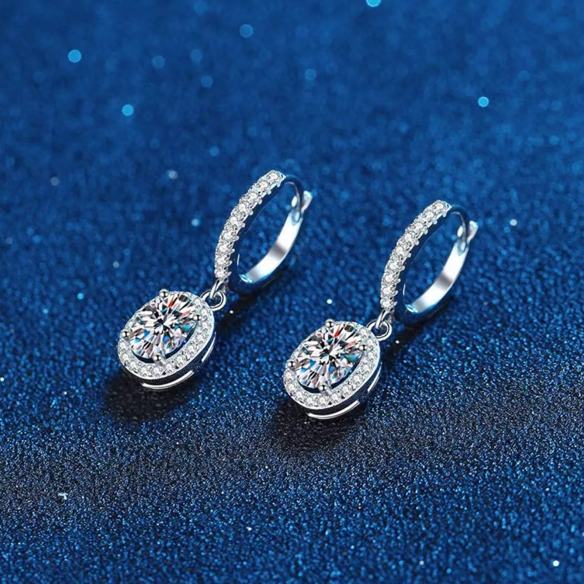 Sterling silver drop earrings worn on the ear