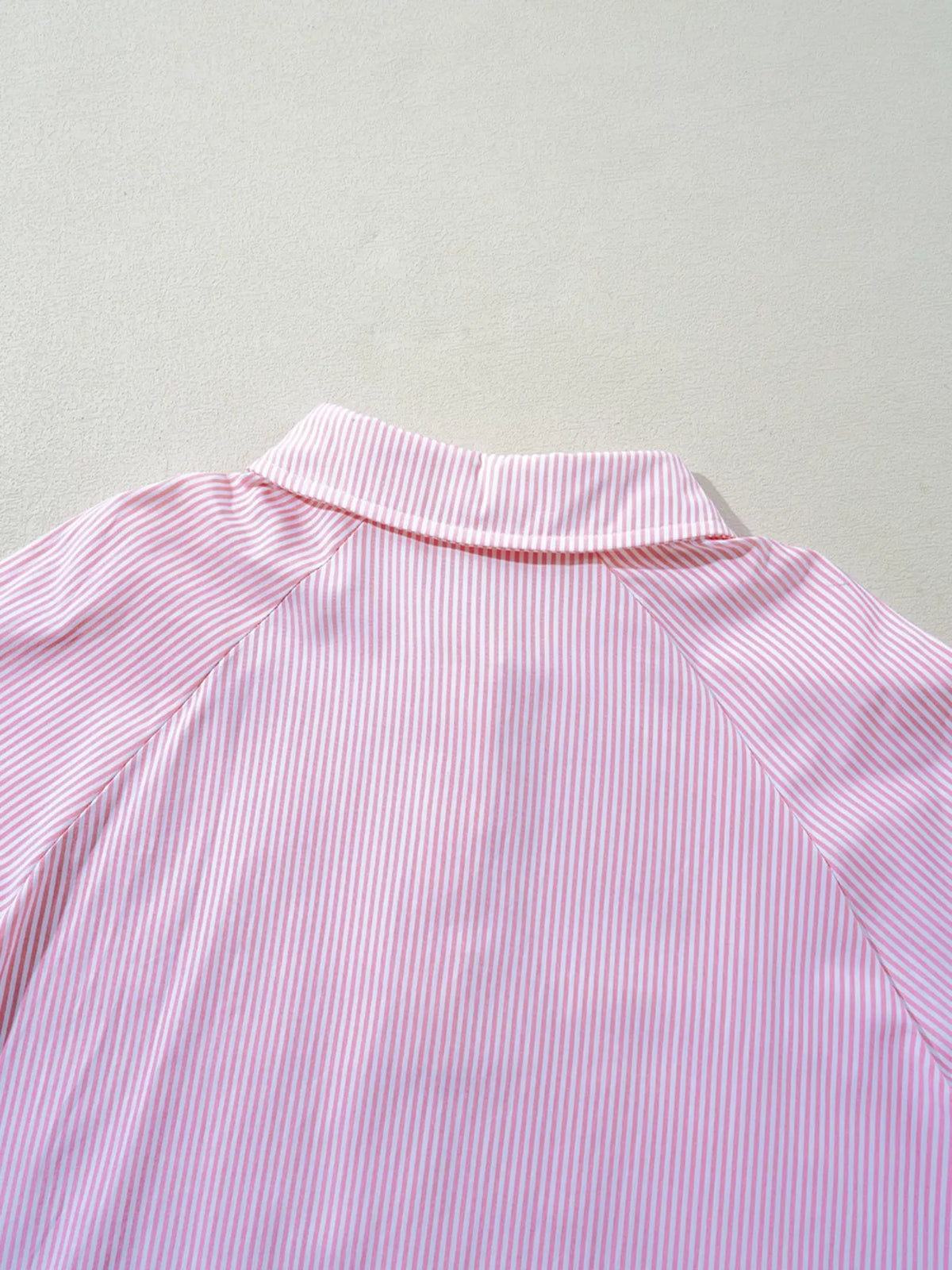 Blouse worn tucked into tailored trousers