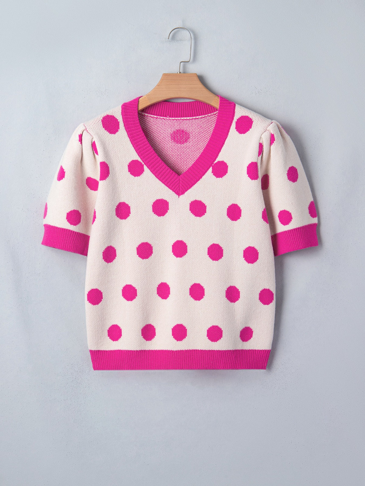 Model wearing pink polka dot puff sleeve top