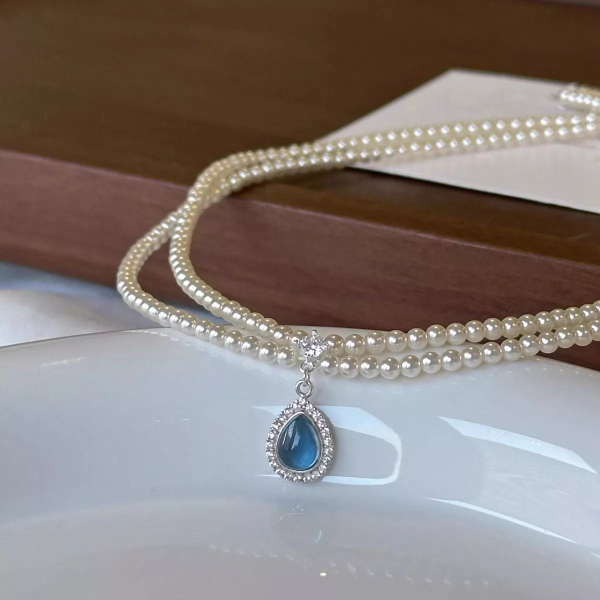 Double layered pearl teardrop pendant necklace close up detail