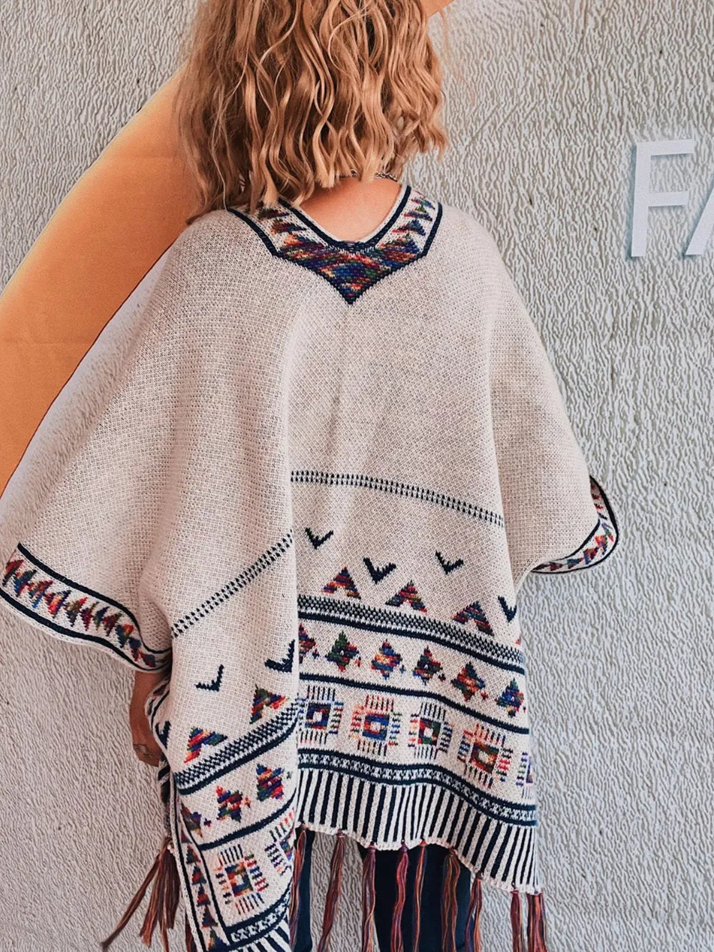 Apricot fringe cardigan styled over a tank and jeans