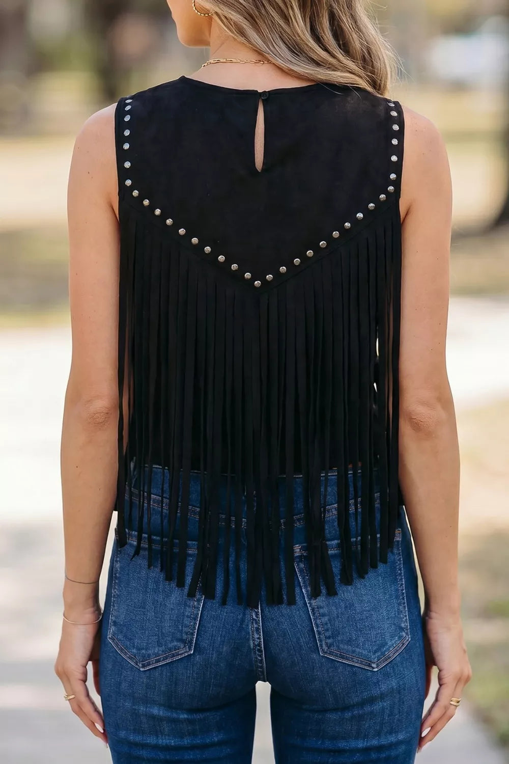 Black western top with tassel fringe on a model