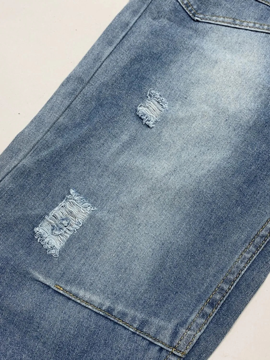 Faded light blue distressed denim