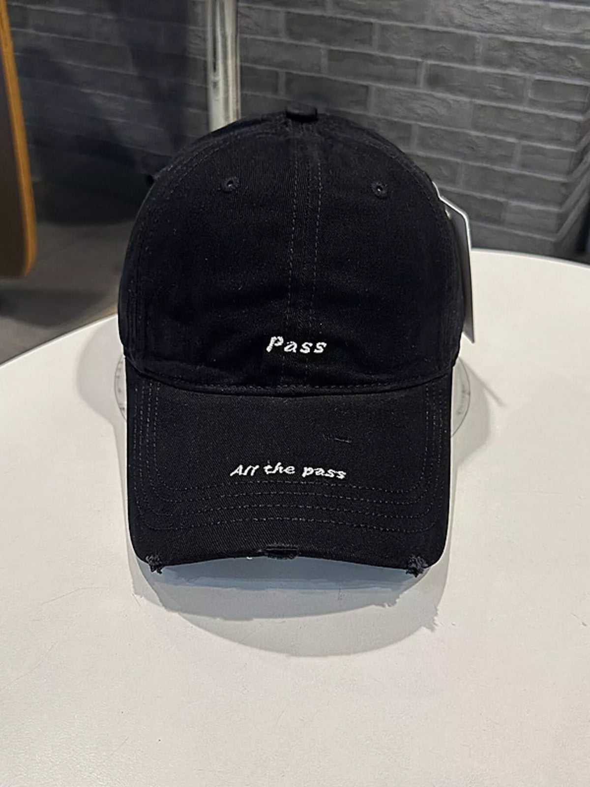 Washed cotton baseball cap frayed edge detail view