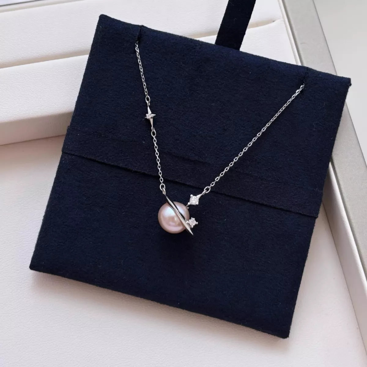 Planet pearl pendant necklace on sterling silver chain on model