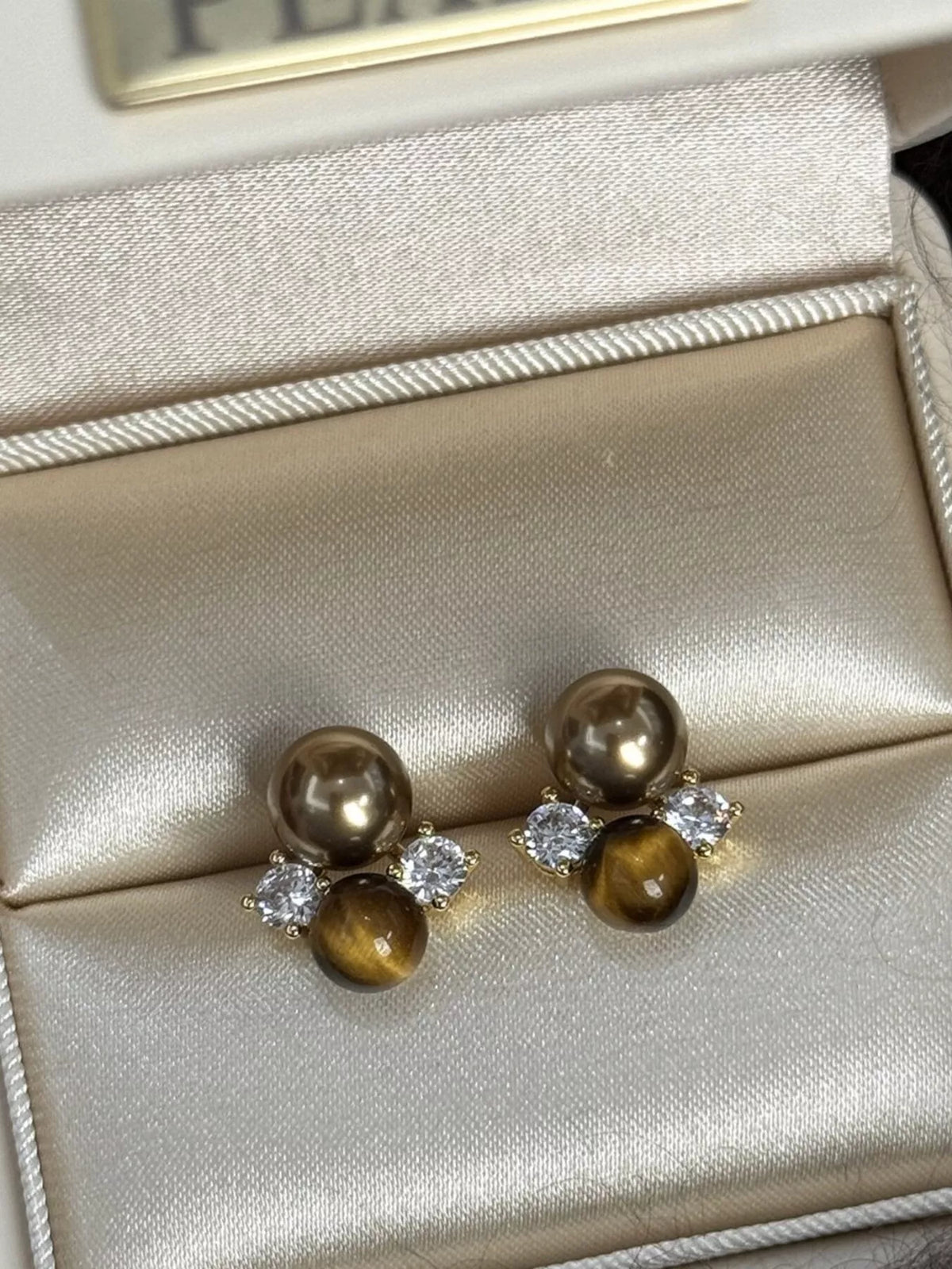 Tiger eye stud earrings with pearl and zircon front view