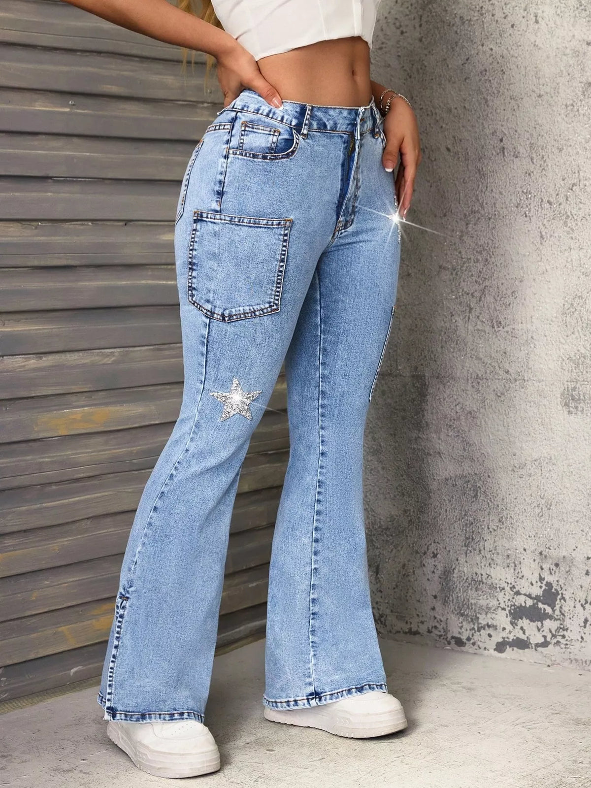 Blue flare leg jeans with star slit hem side view