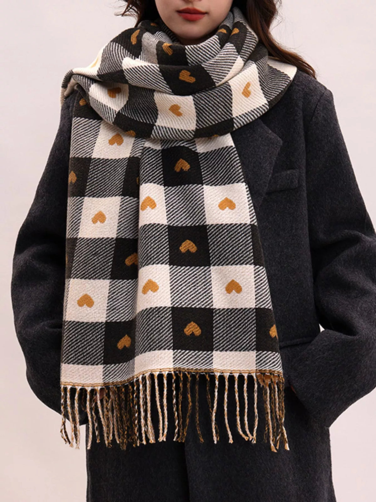 Close up of heart motifs on plaid tassel scarf