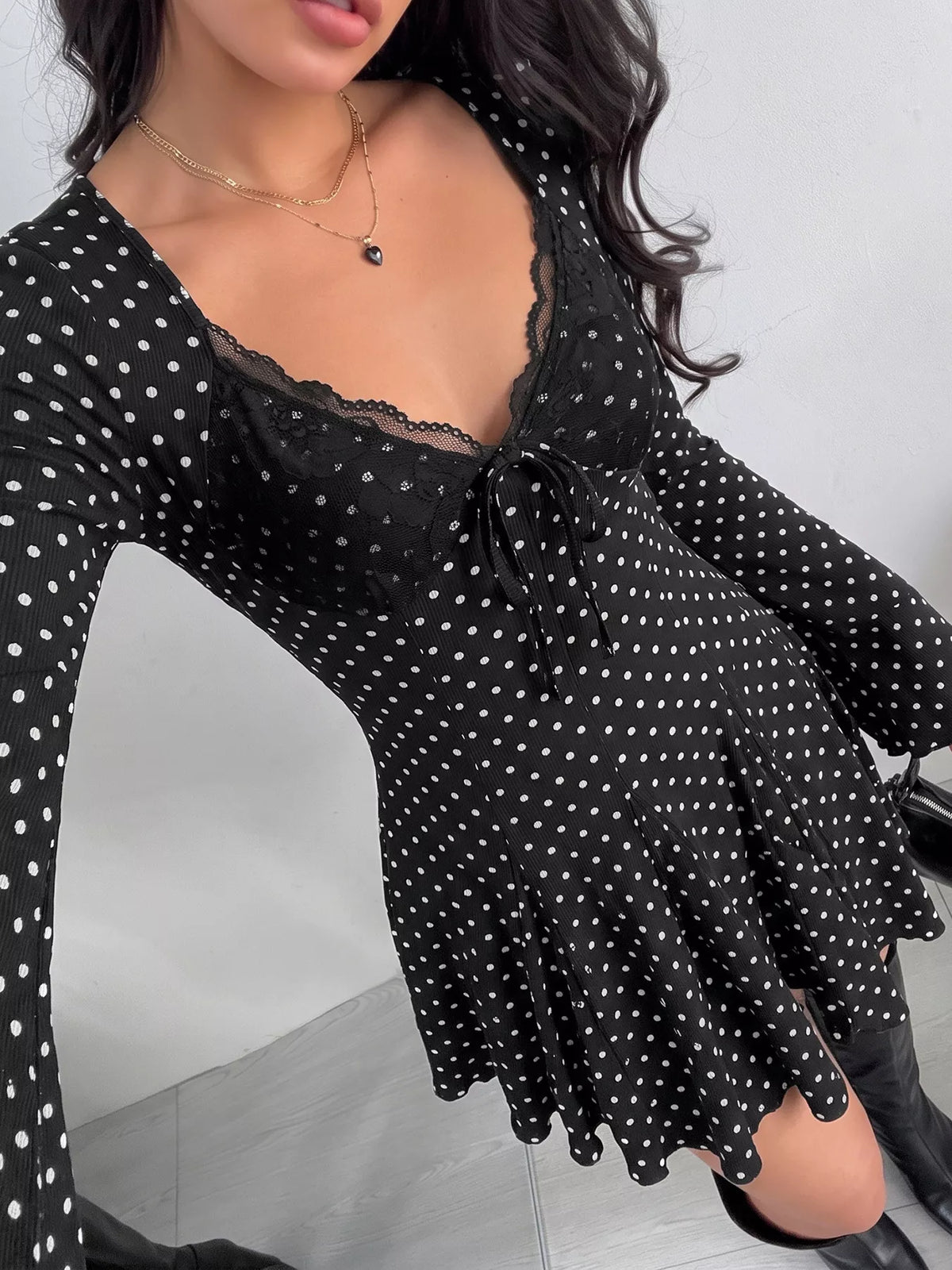 Lace trim detail on black polka dot dress