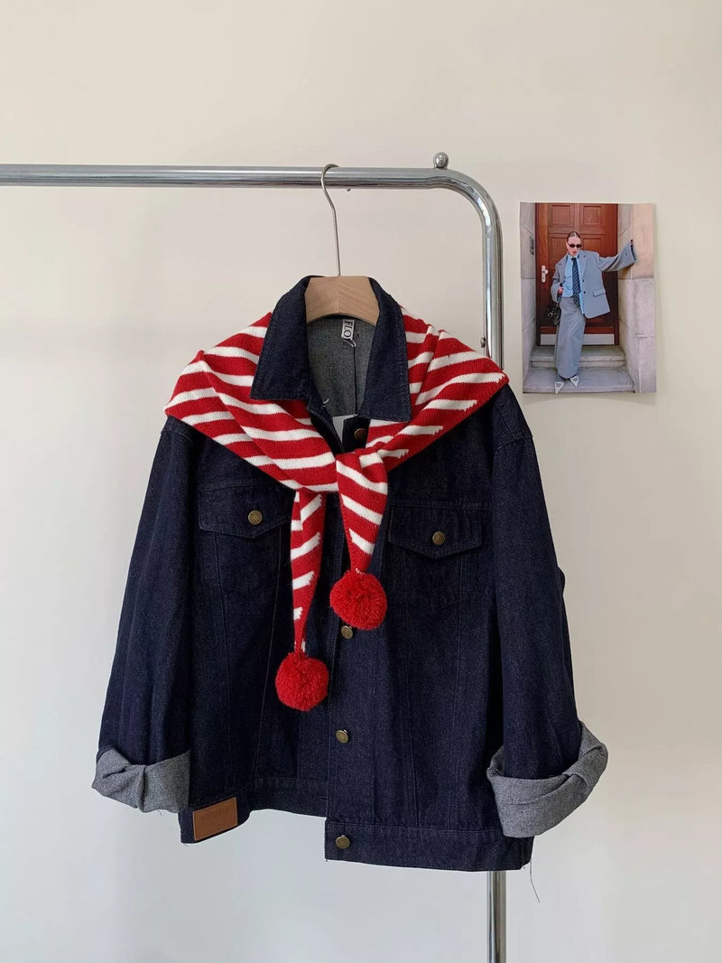Striped pom pom knit scarf wrapped around the neck