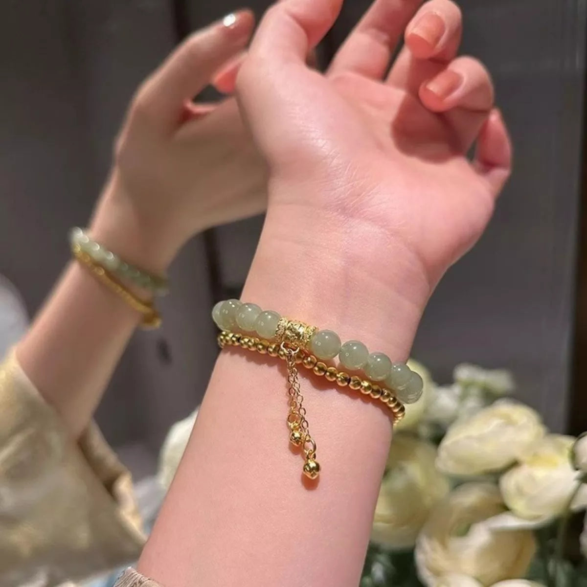Green jade beaded bracelet on wrist
