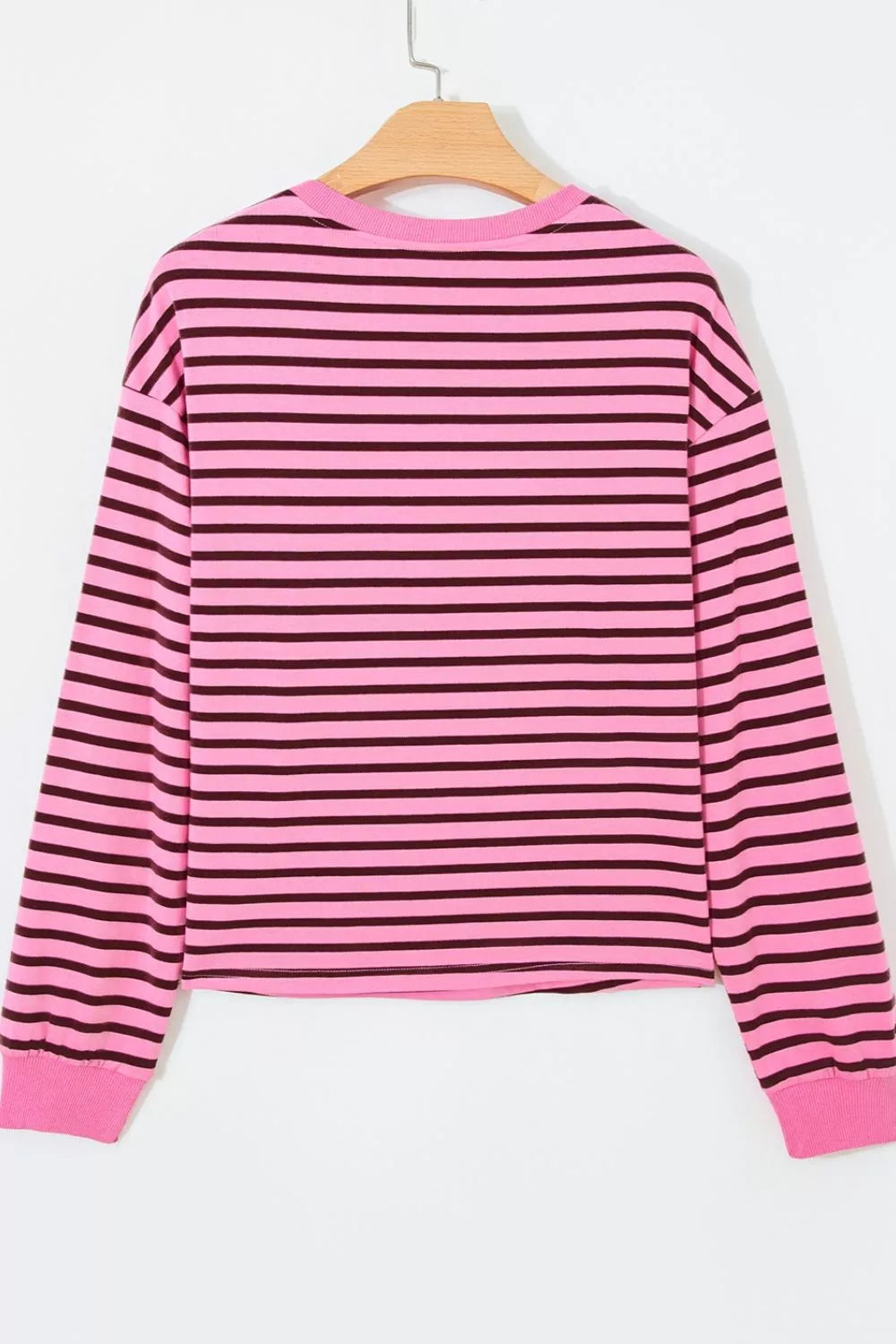 Striped top shown untucked over a casual trouser