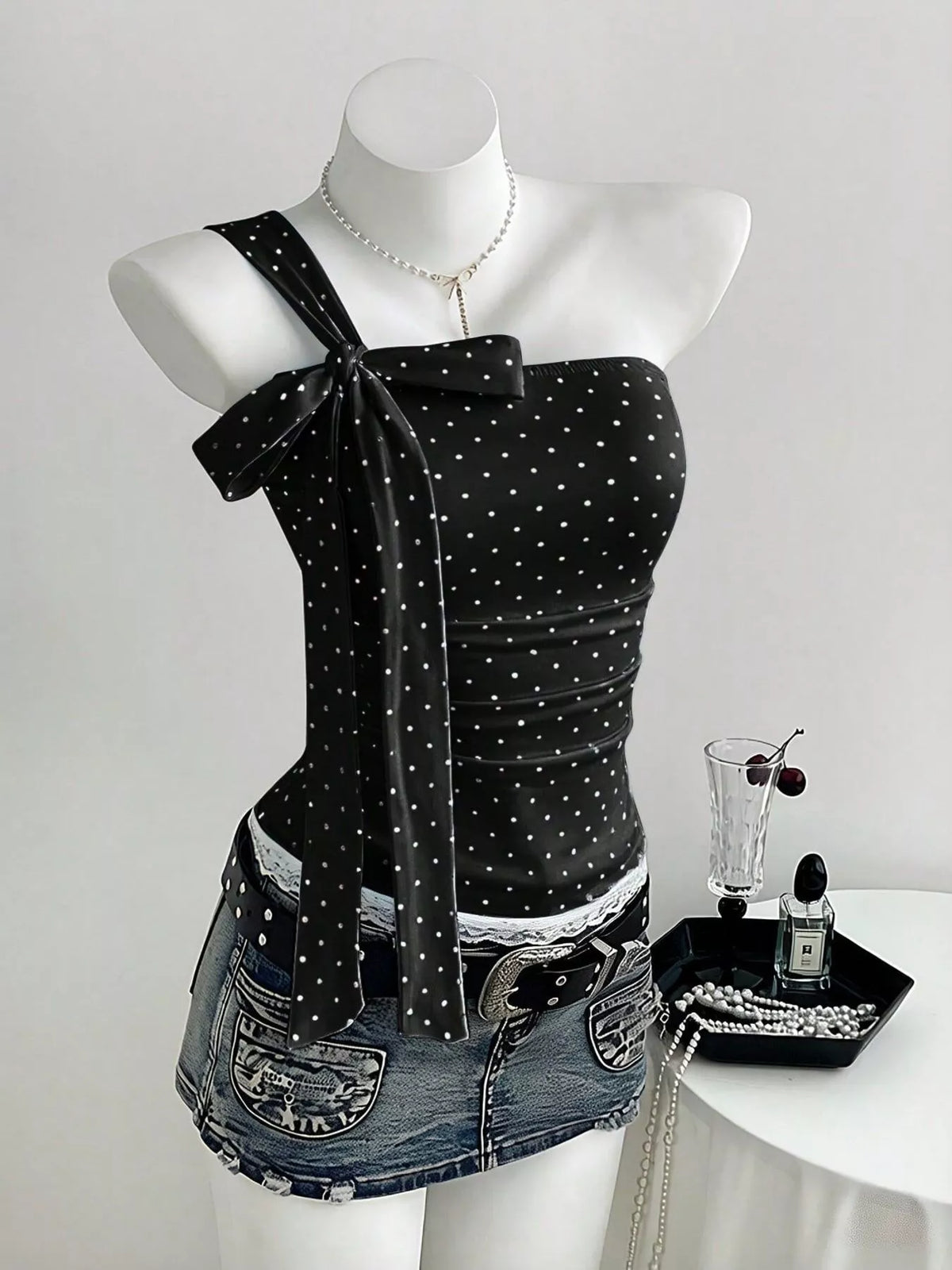 Polka dot one shoulder cami in black, front view