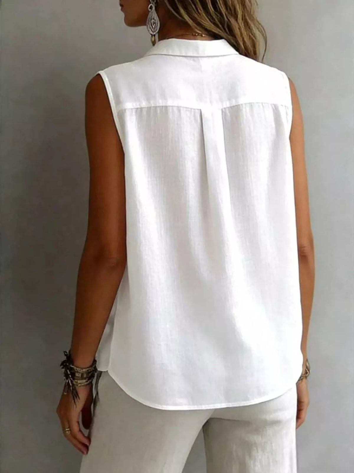 Sleeveless collared button down shirt close up view