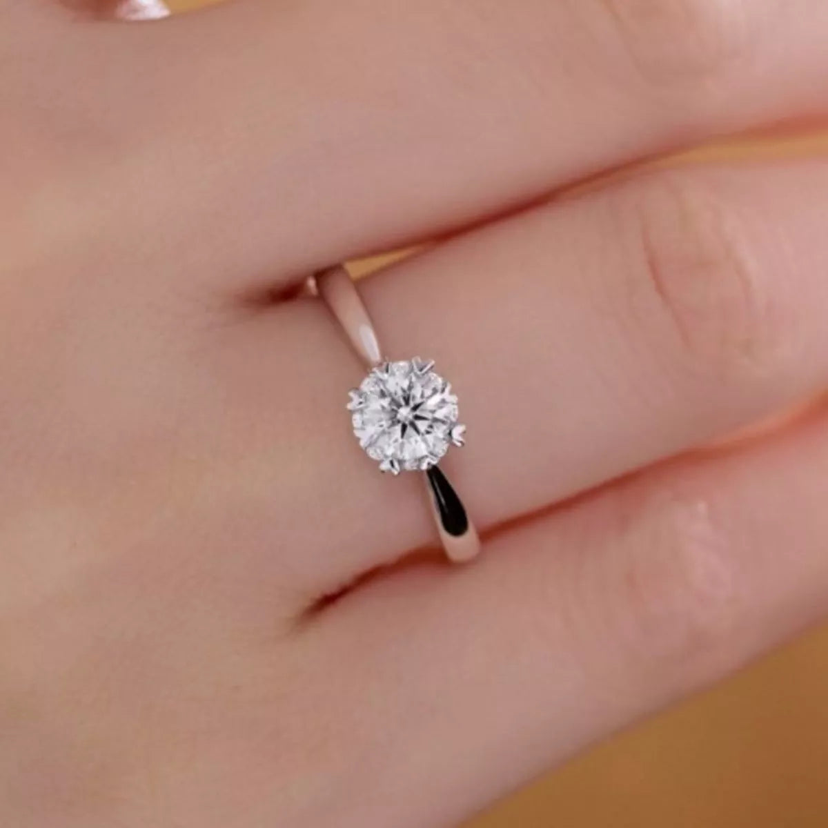 Adjustable silver moissanite ring worn on the hand