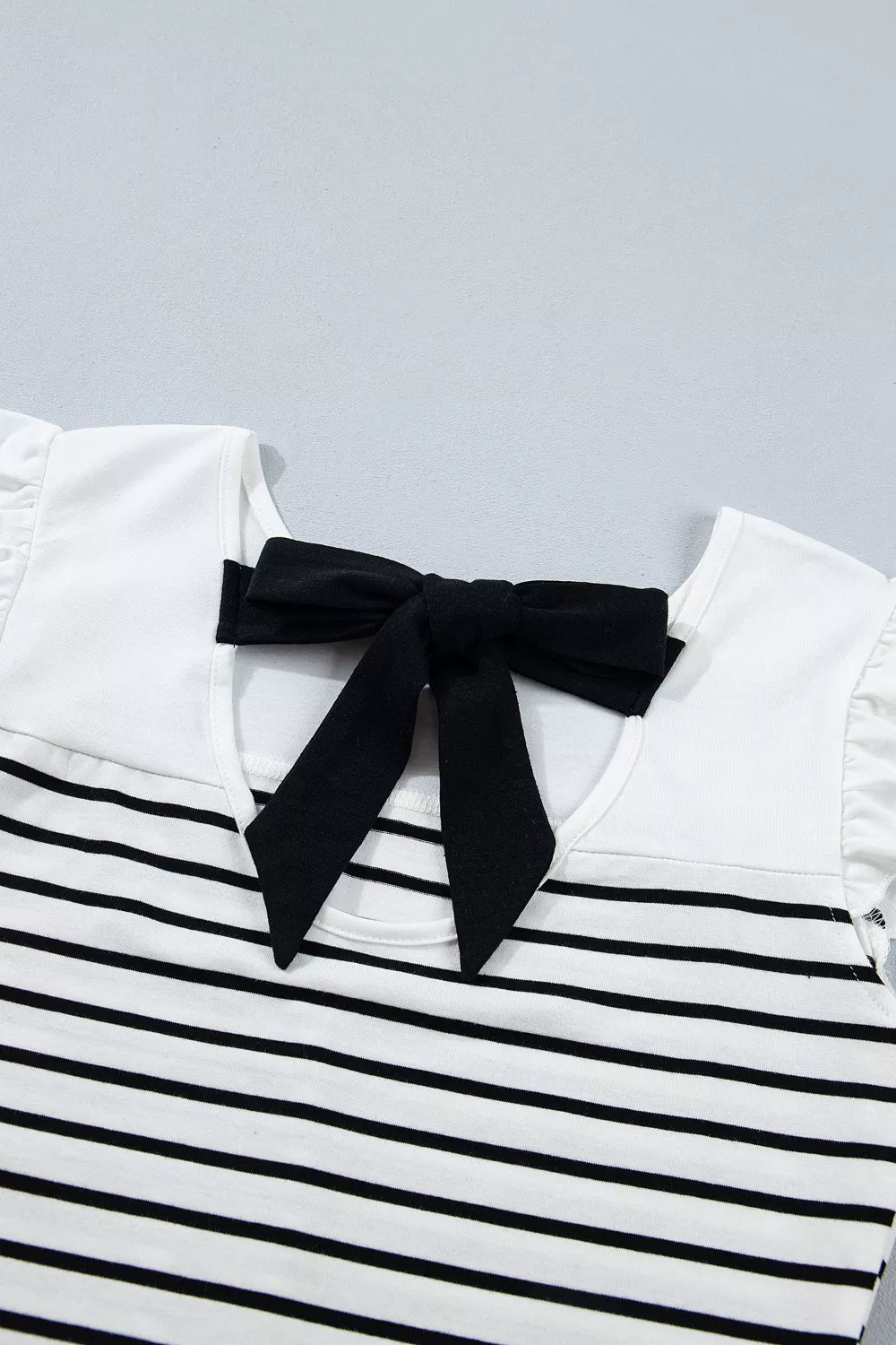 Ruffle trim and stripe contrast panel fabric close up