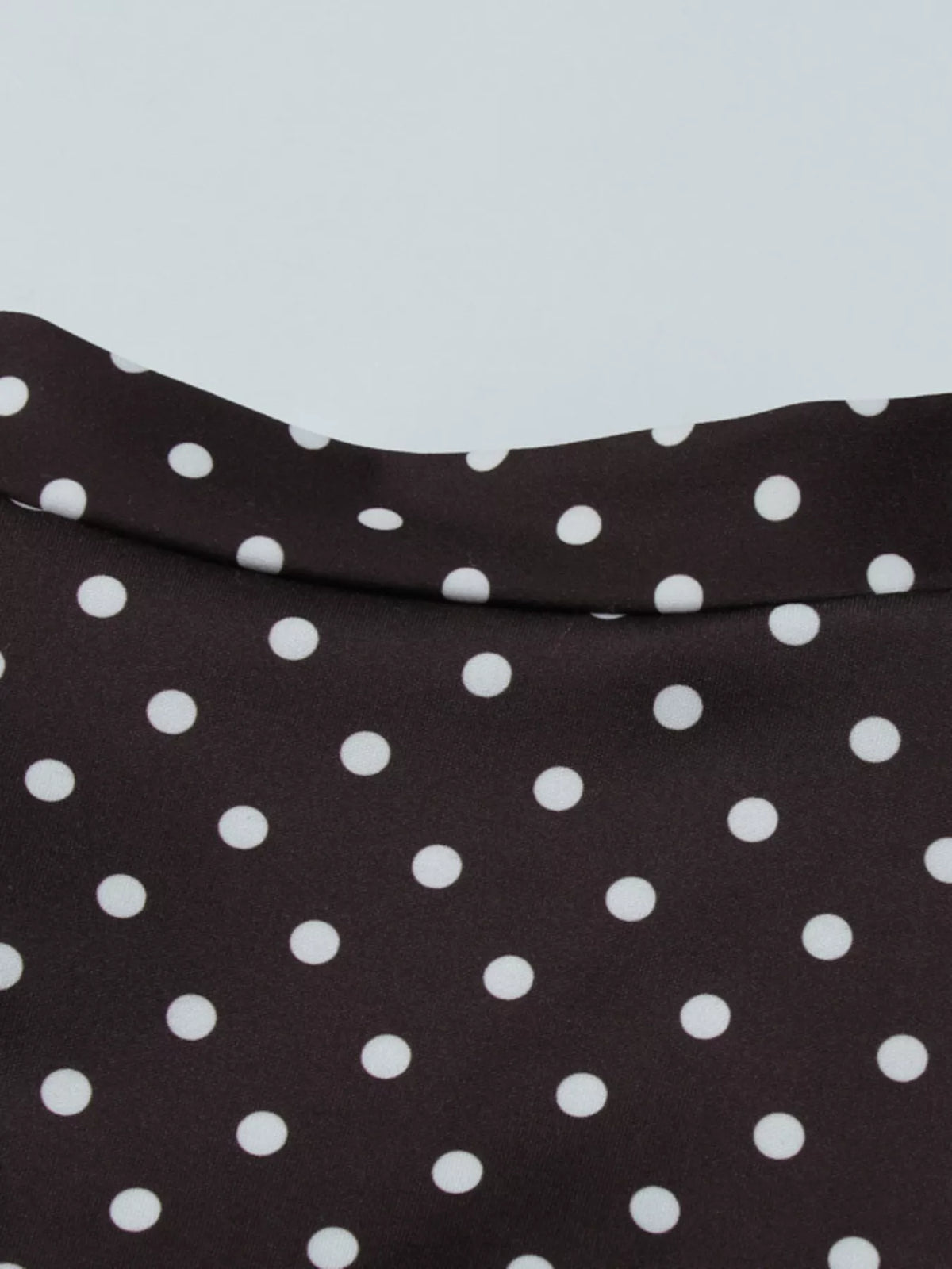 Brown polka dot dress shown at an angle