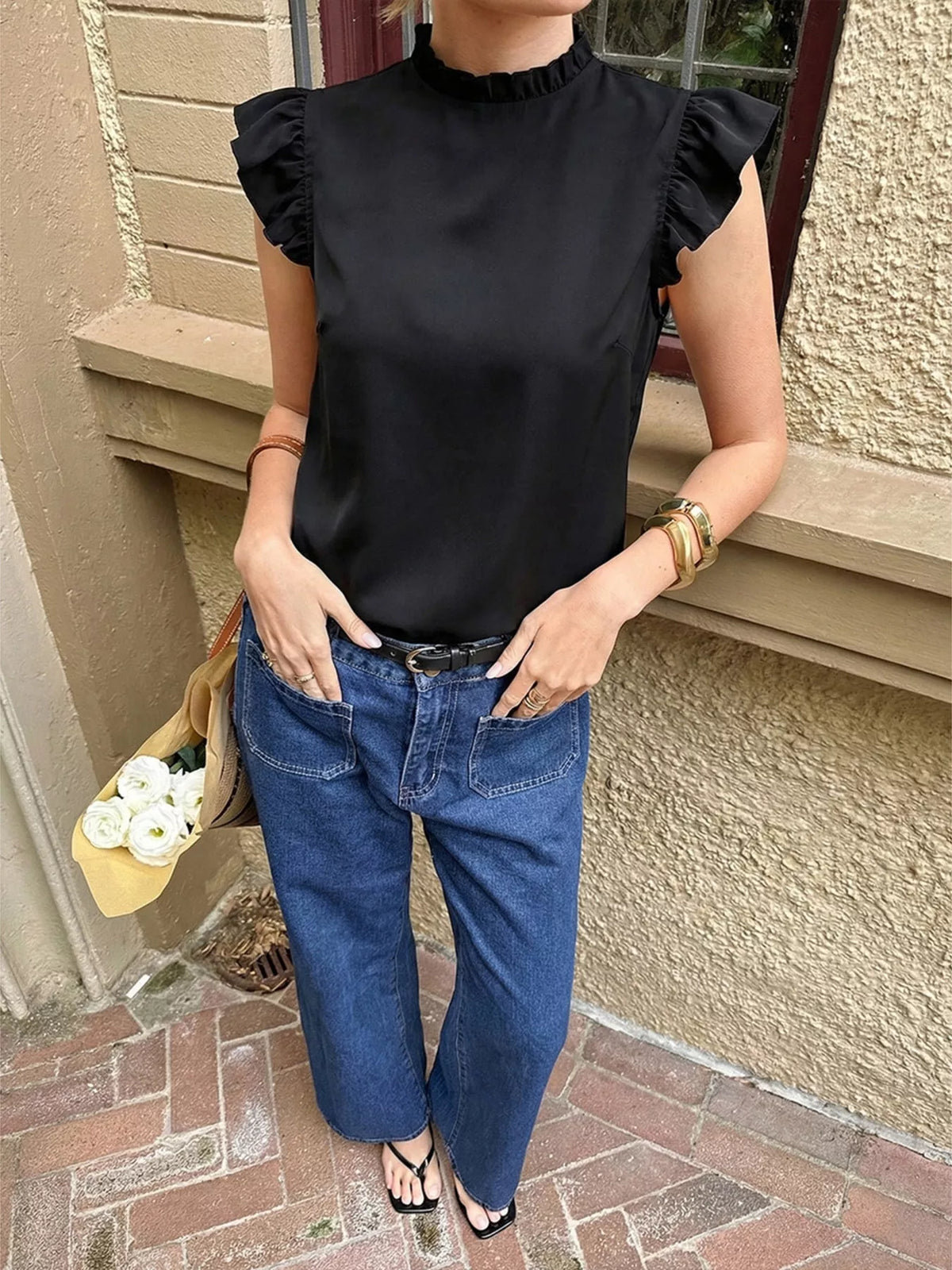 Close up of the ruffle and lace trim on a black top