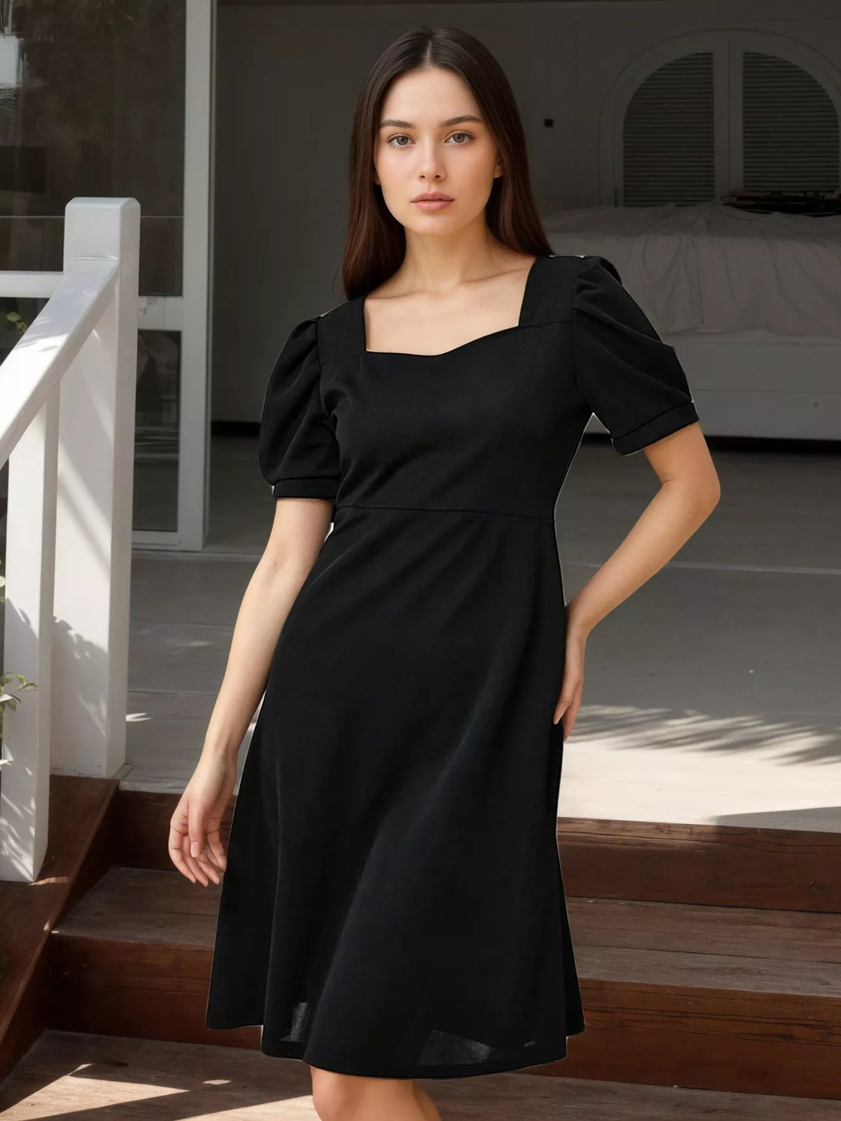 Black puff sleeve bow back mini dress front view