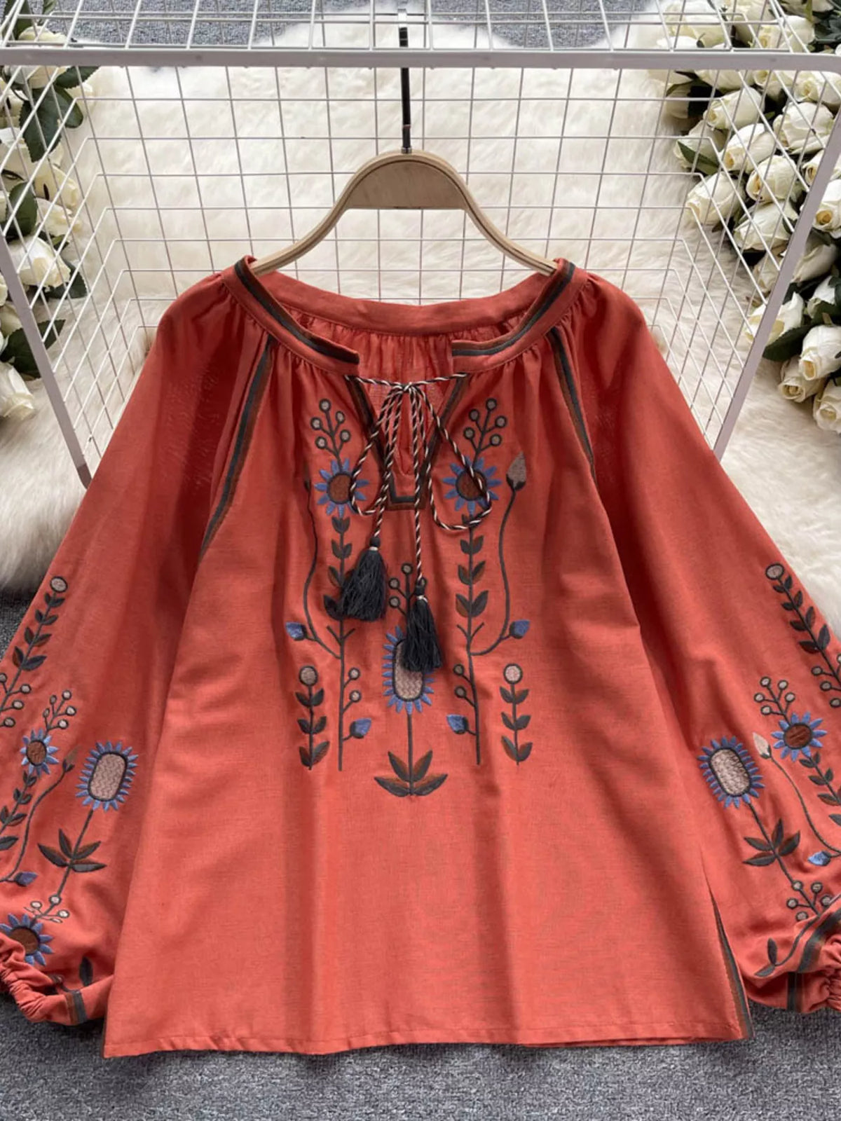 Orange red embroidered tassel blouse styled on model