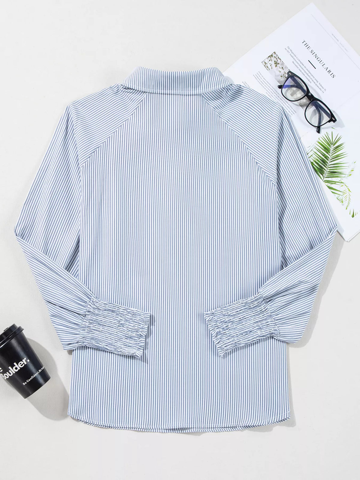 Pinstripe blouse laid flat to show the cut