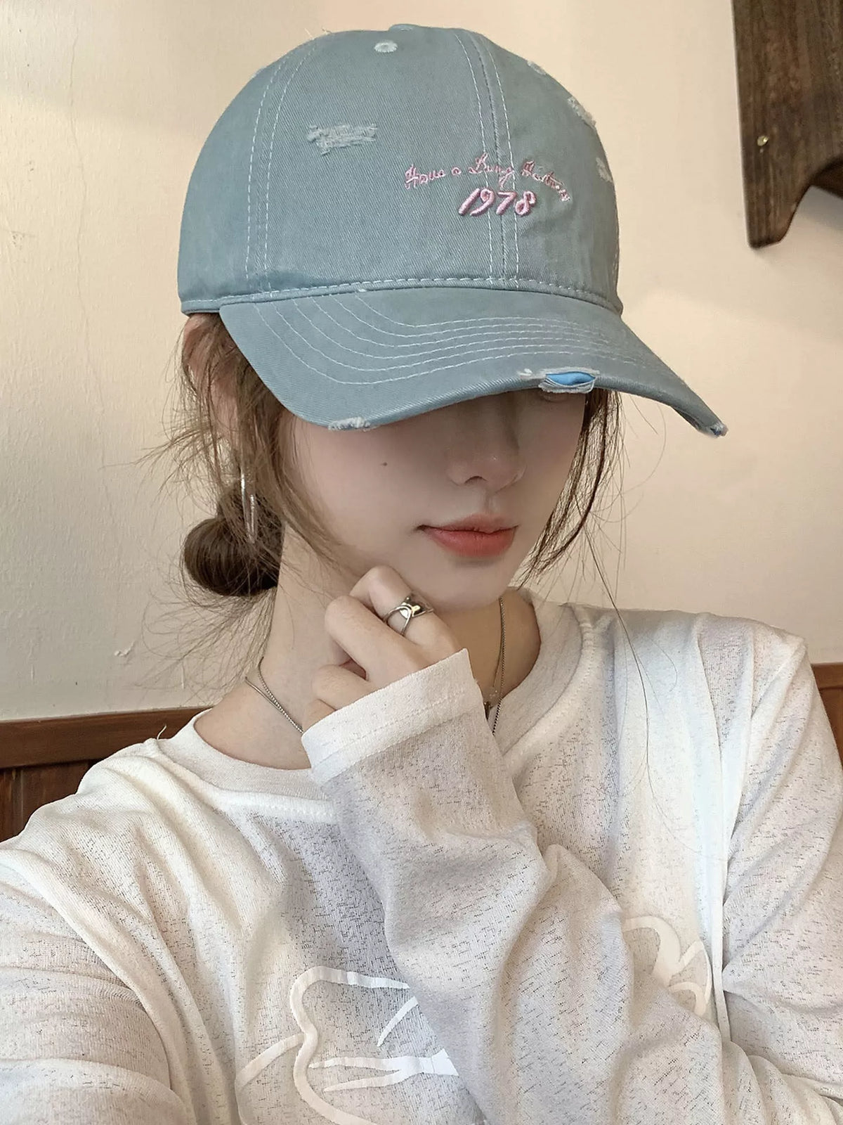 Light blue embroidered distressed baseball cap side view
