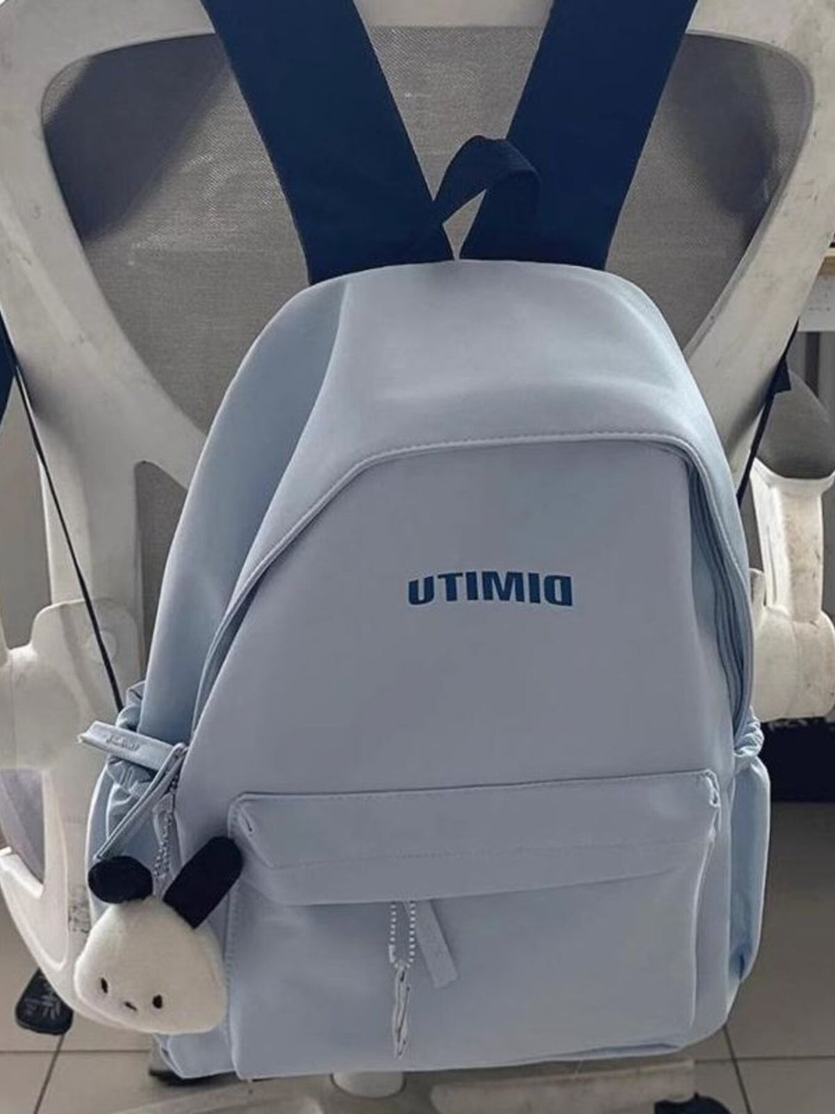 light blue nylon backpack side profile