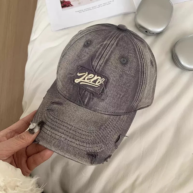 Distressed brim and panel detail on a cotton cap