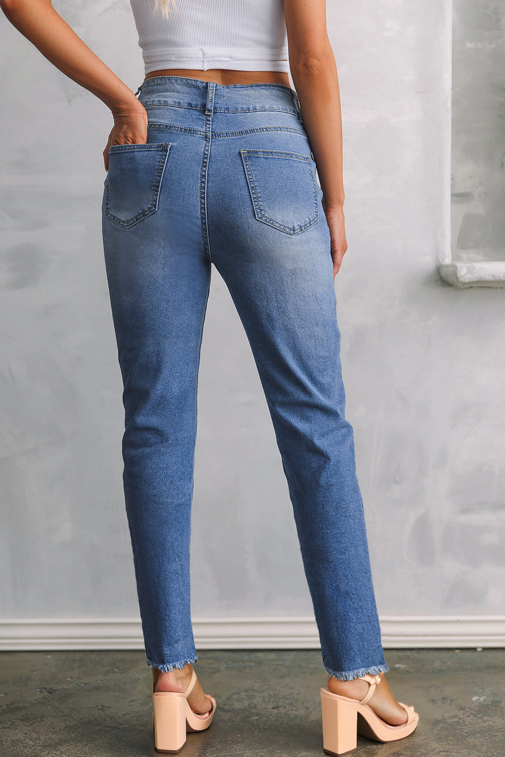 Slim fit blue jeans side view showing cropped length