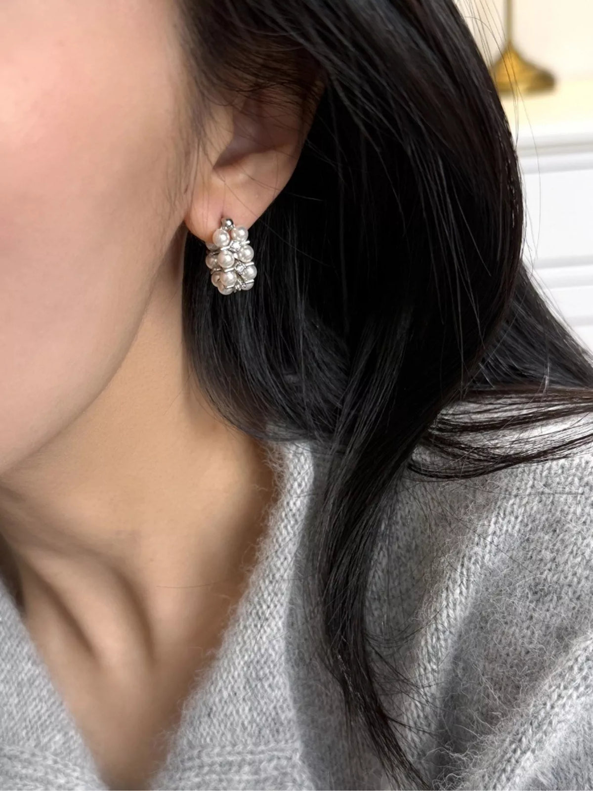 Pearl hoop earring detail close up