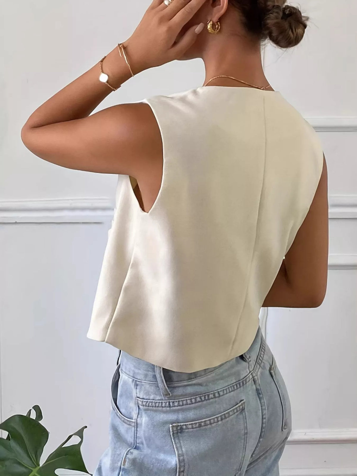 Beige button down sleeveless utility vest detail view