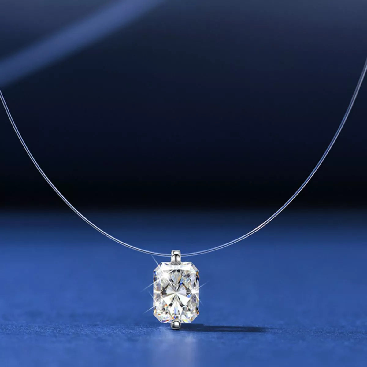 Moissanite solitaire necklace worn at the collarbone