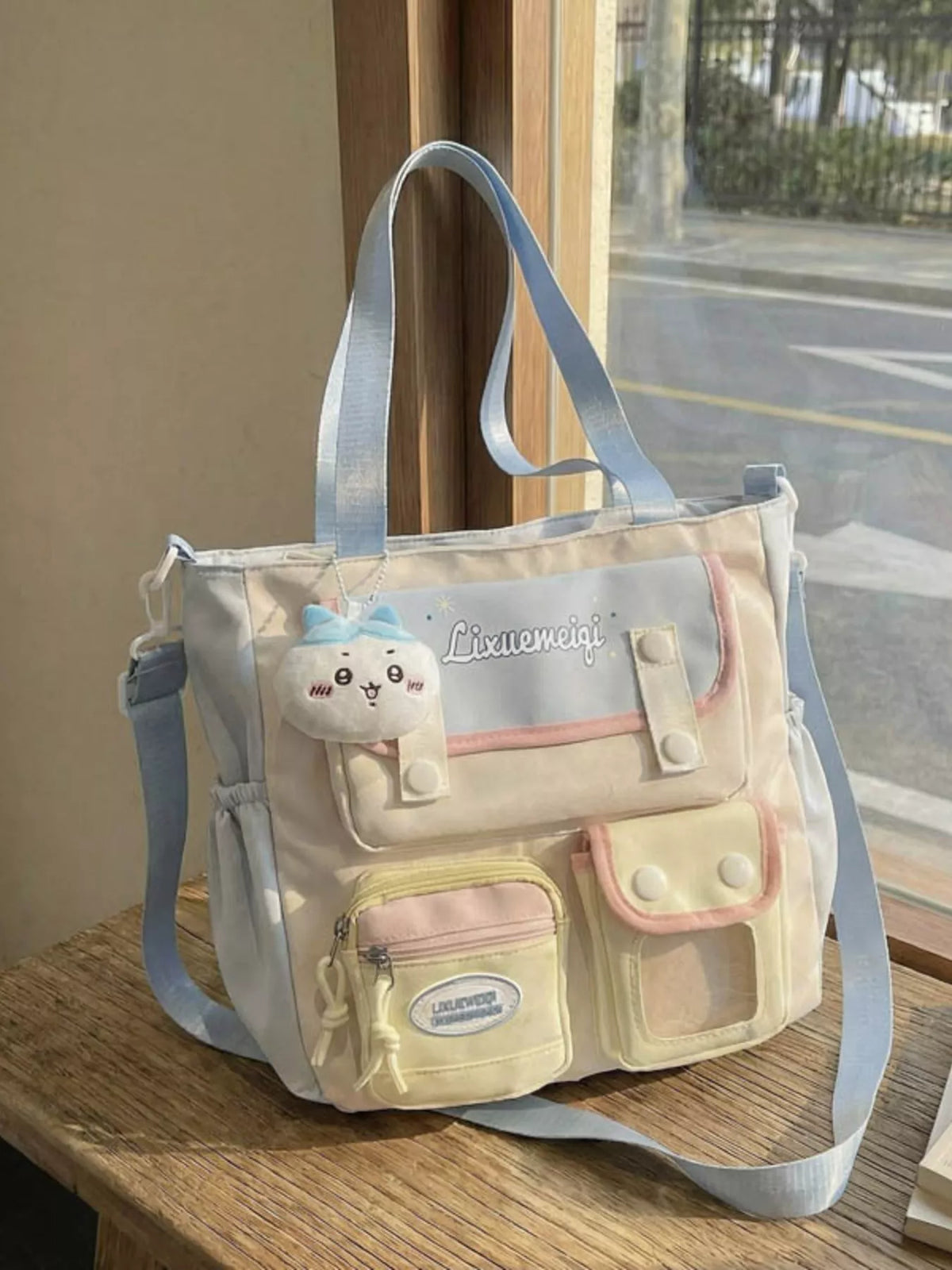 Close up of front pockets on pastel blue bag