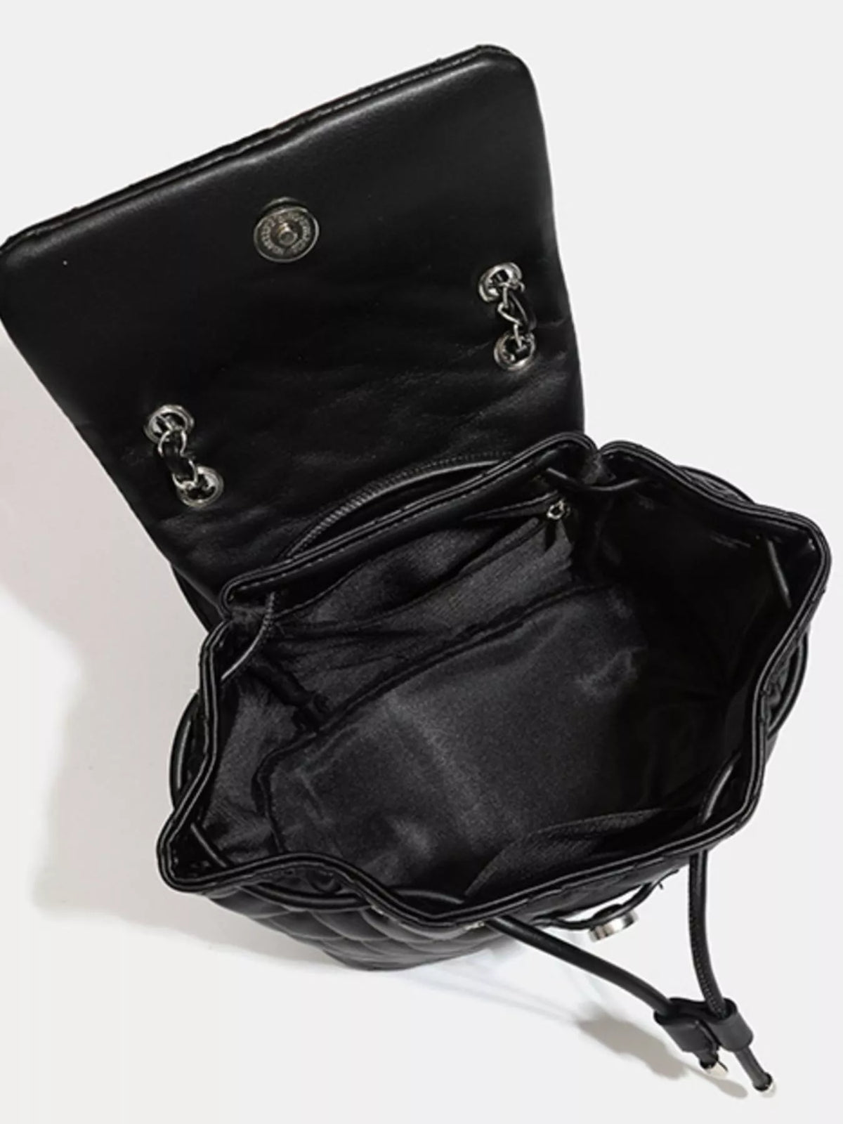 Black quilted chain flap backpack side profile