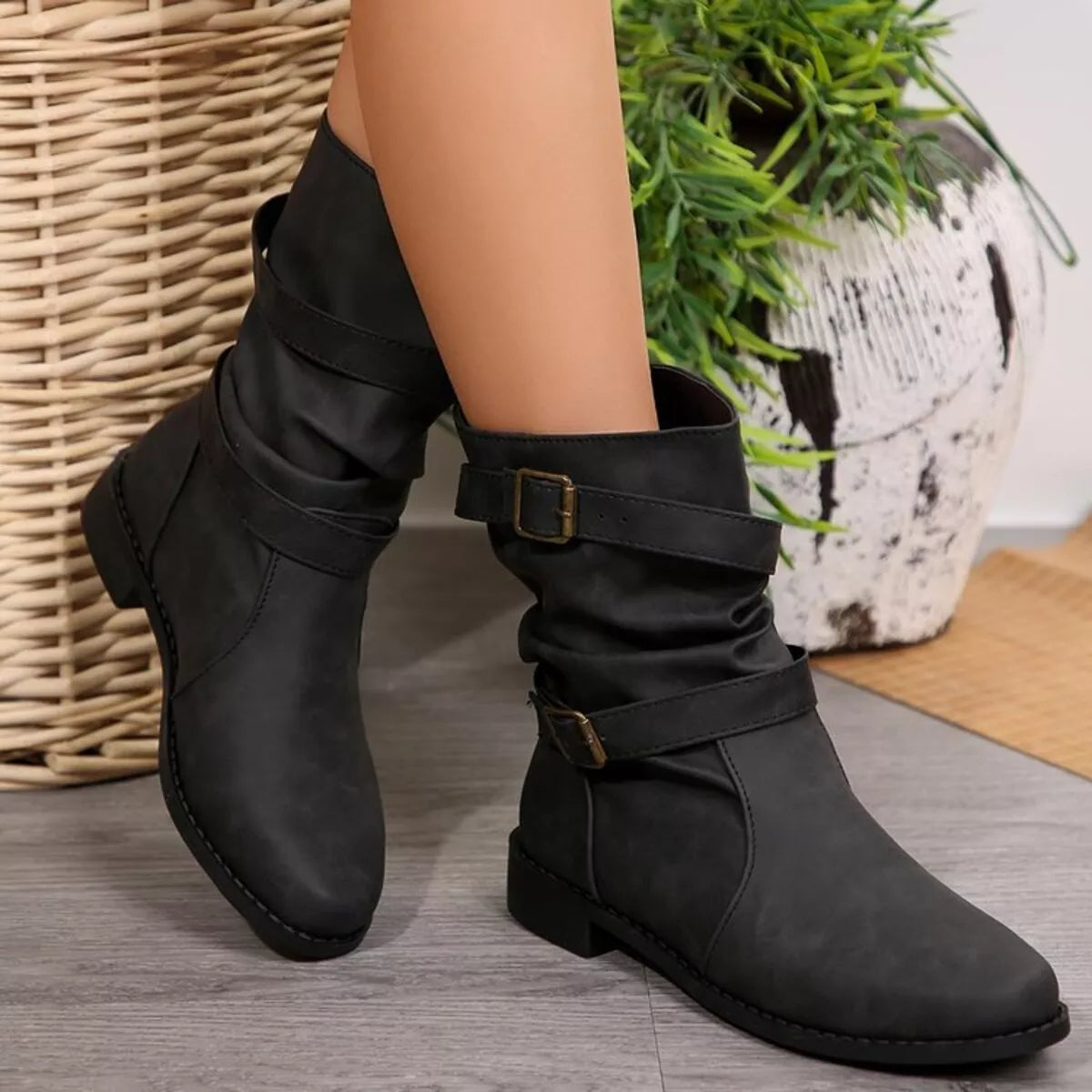 Buckled low heel boots angled three quarter view
