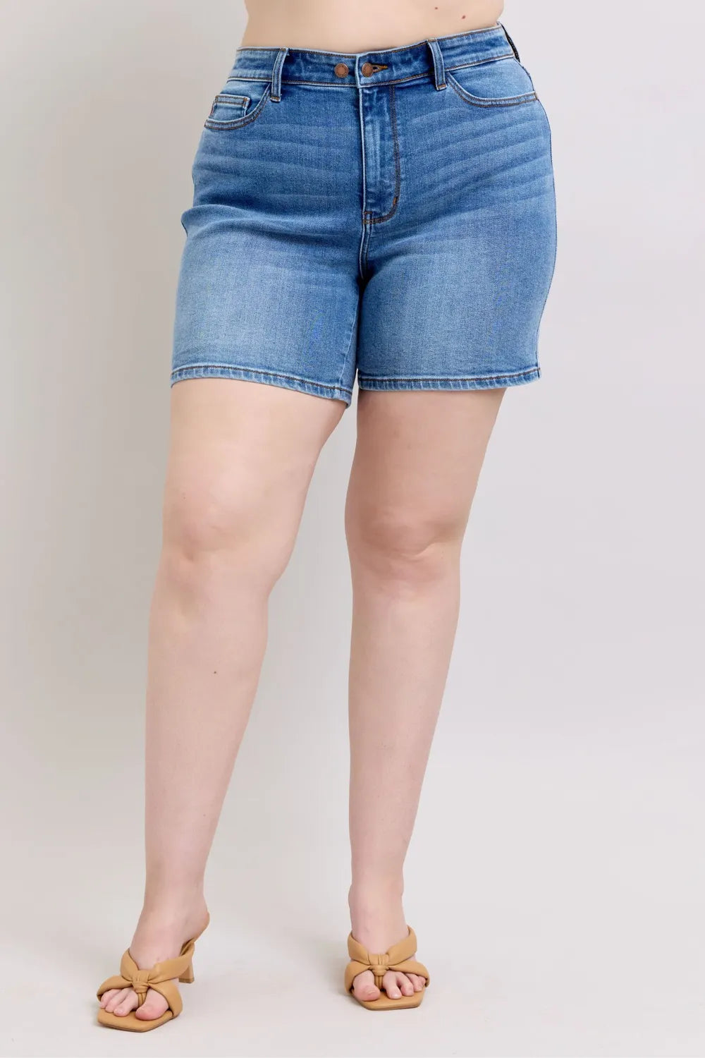 Two button denim shorts with pockets front view