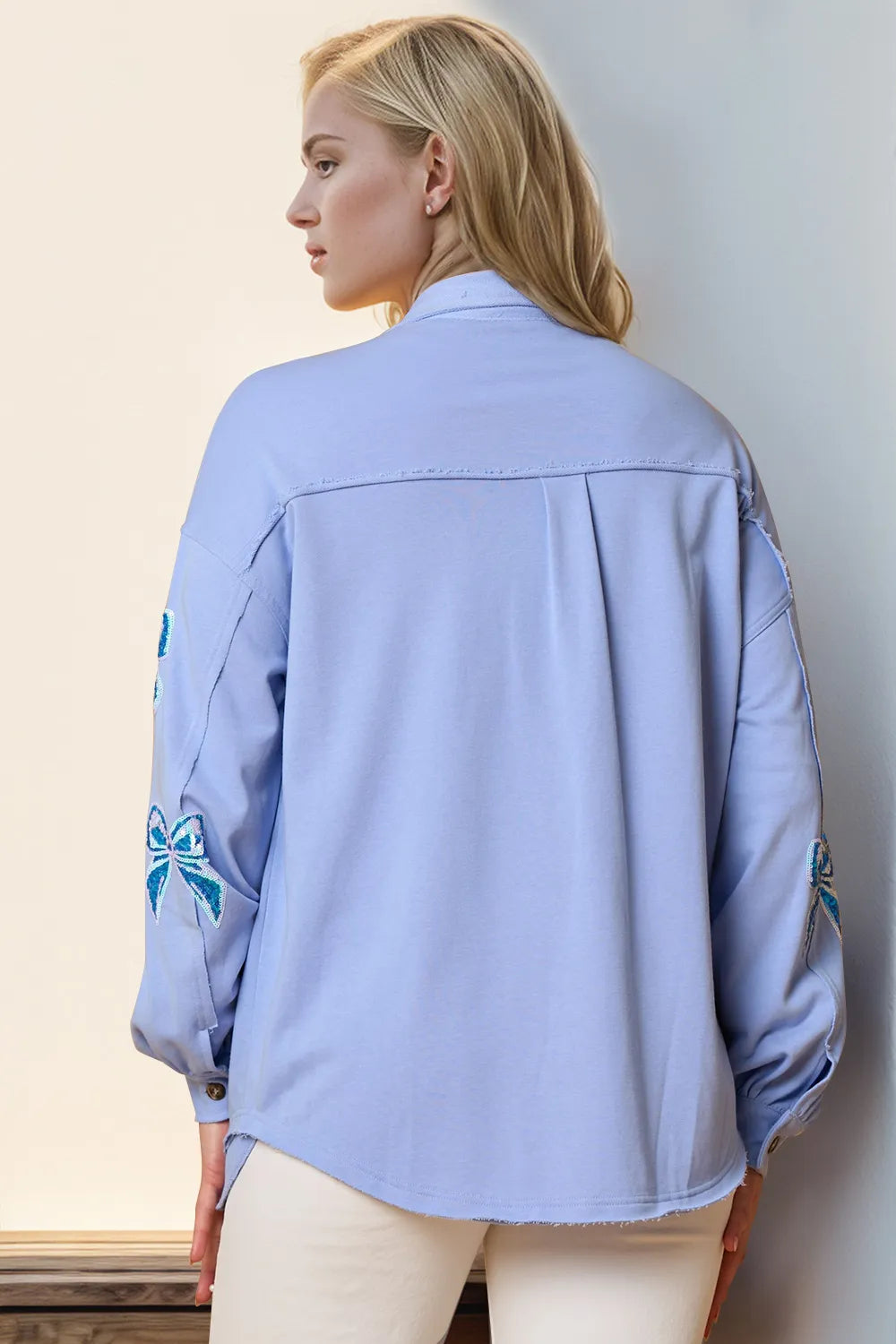 Sequin shacket shown buttoned with bow detail