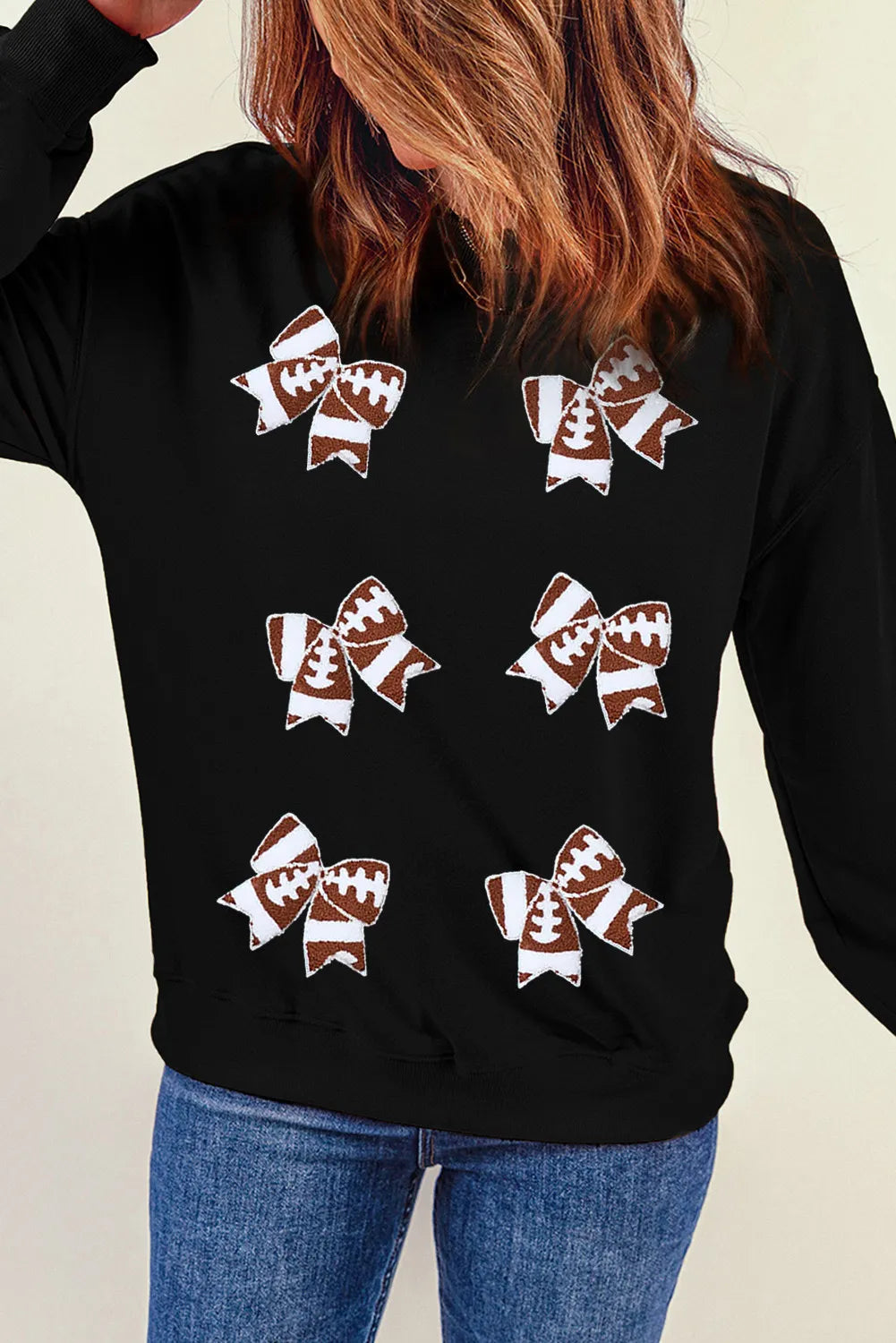 Black sweatshirt with subtle bow accent detail