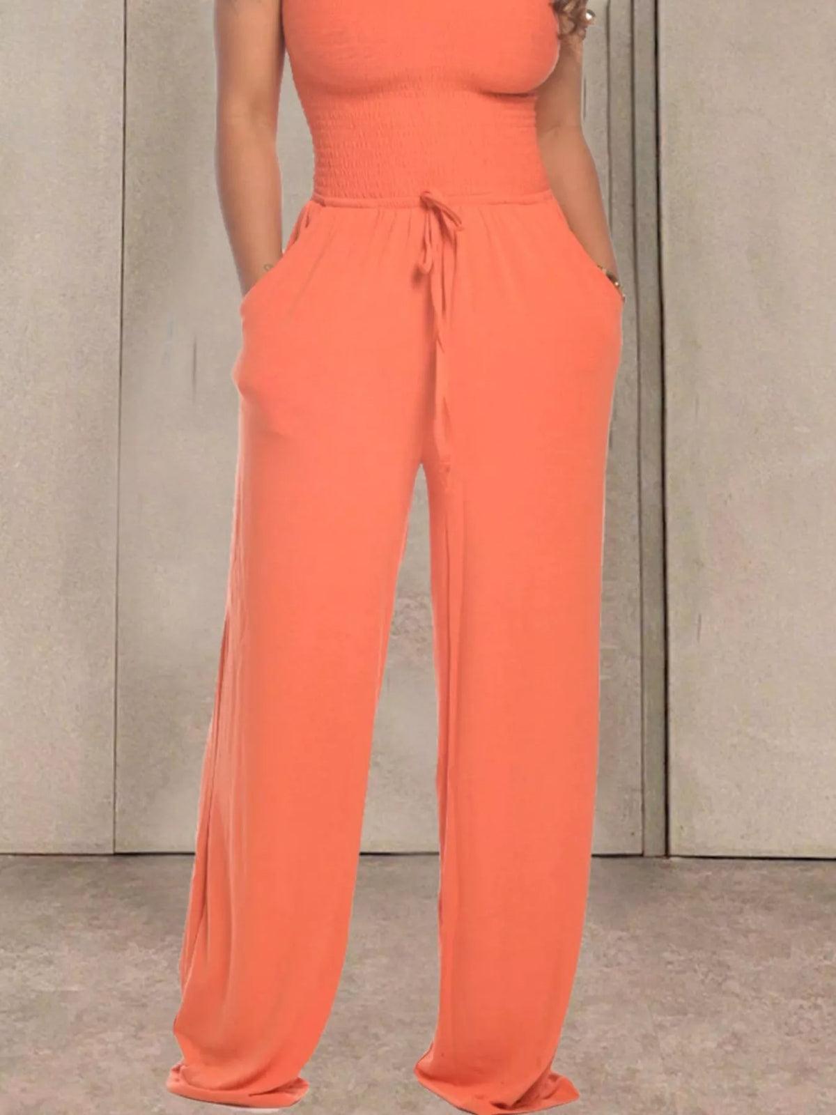 Pink strapless smocked wide leg jumpsuit styled view