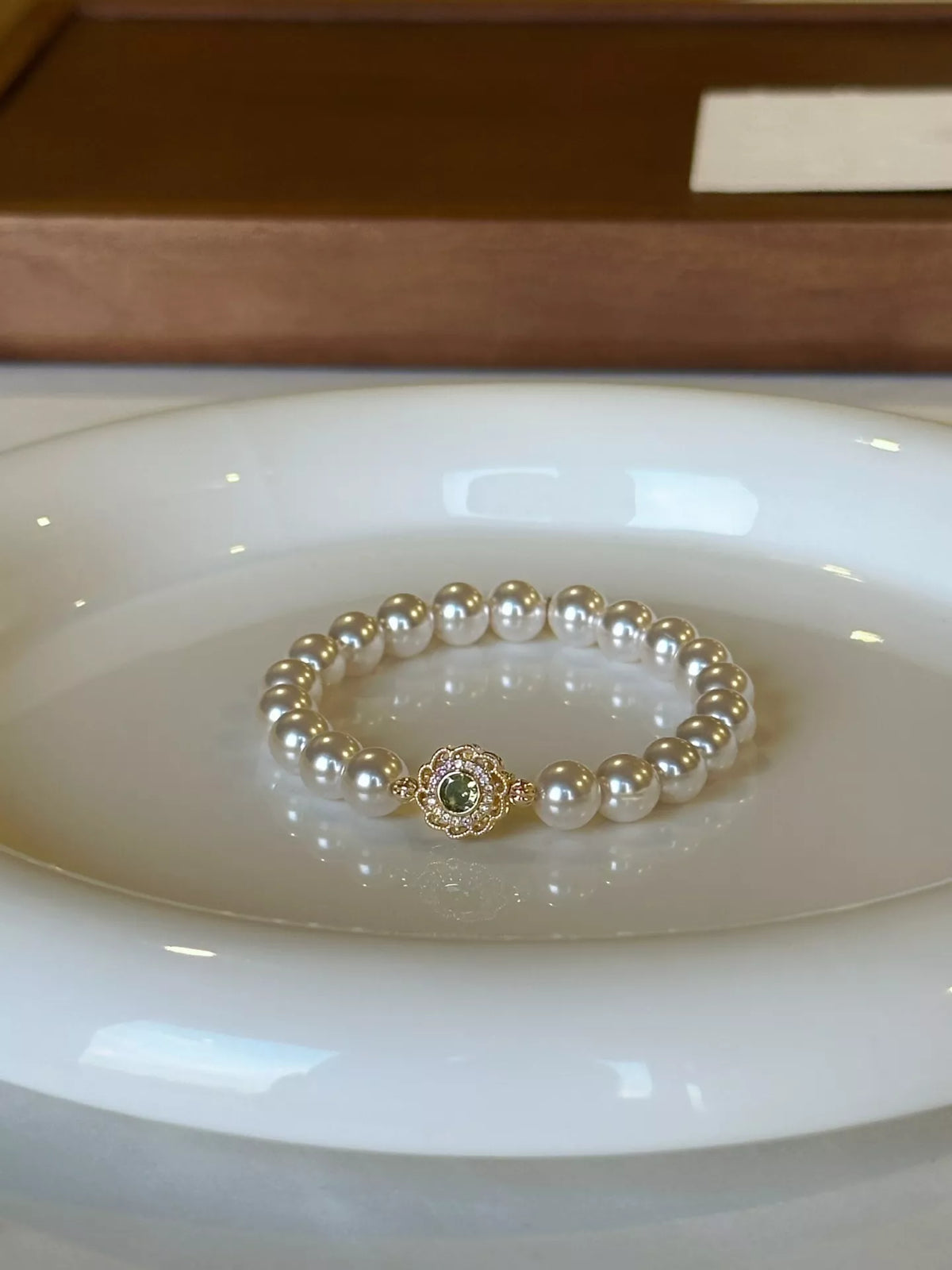 gold pearl flower bracelet flat lay