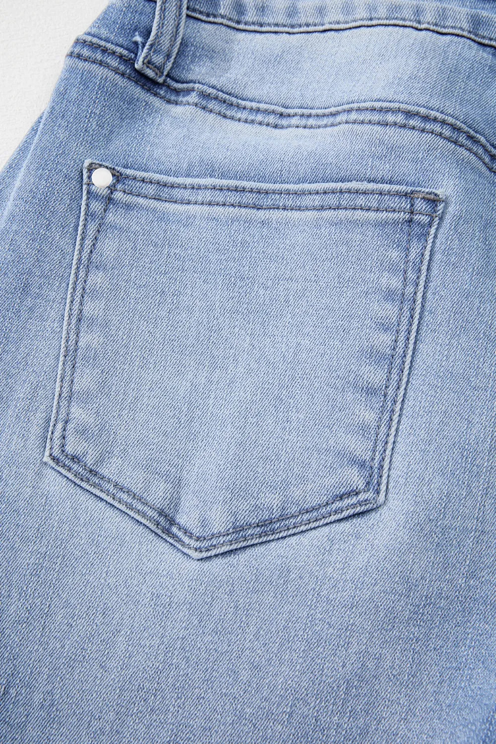 Model posing in mineral wash flare jeans