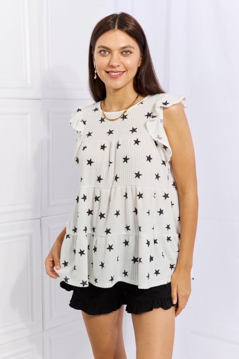 Front view of the white star print top