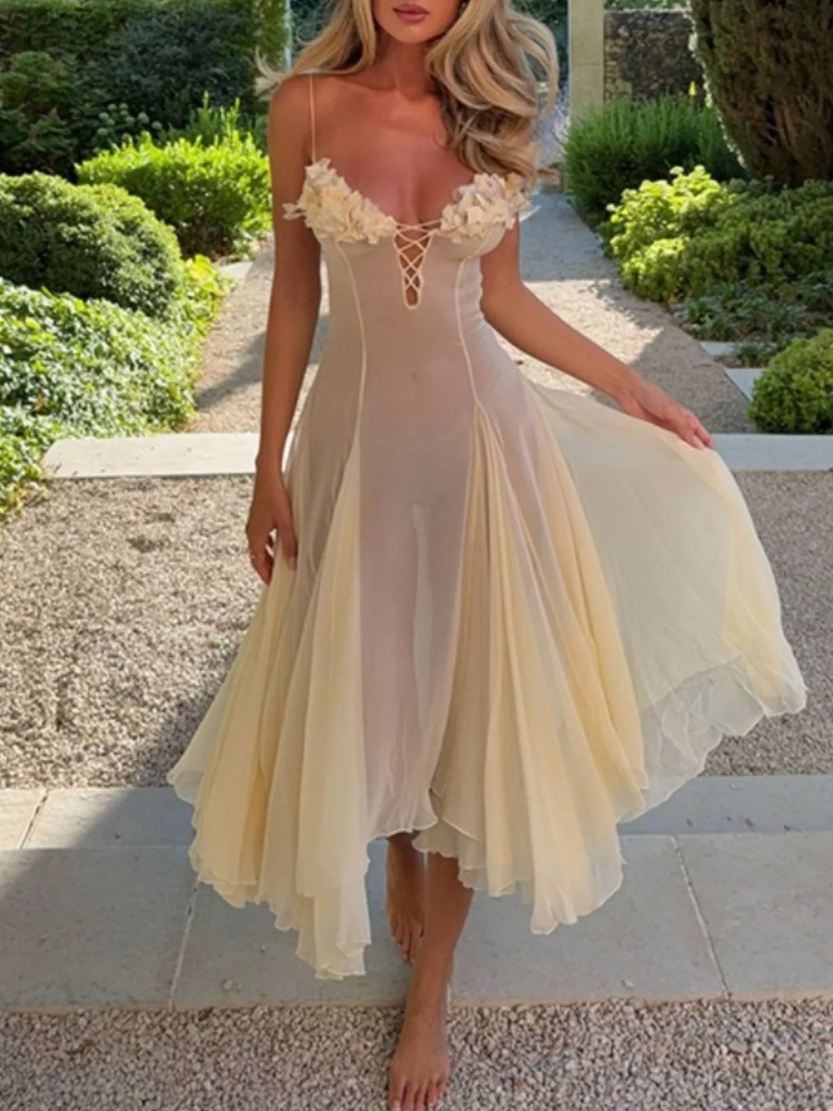 Embellished floral detail on the yellow dress fabric