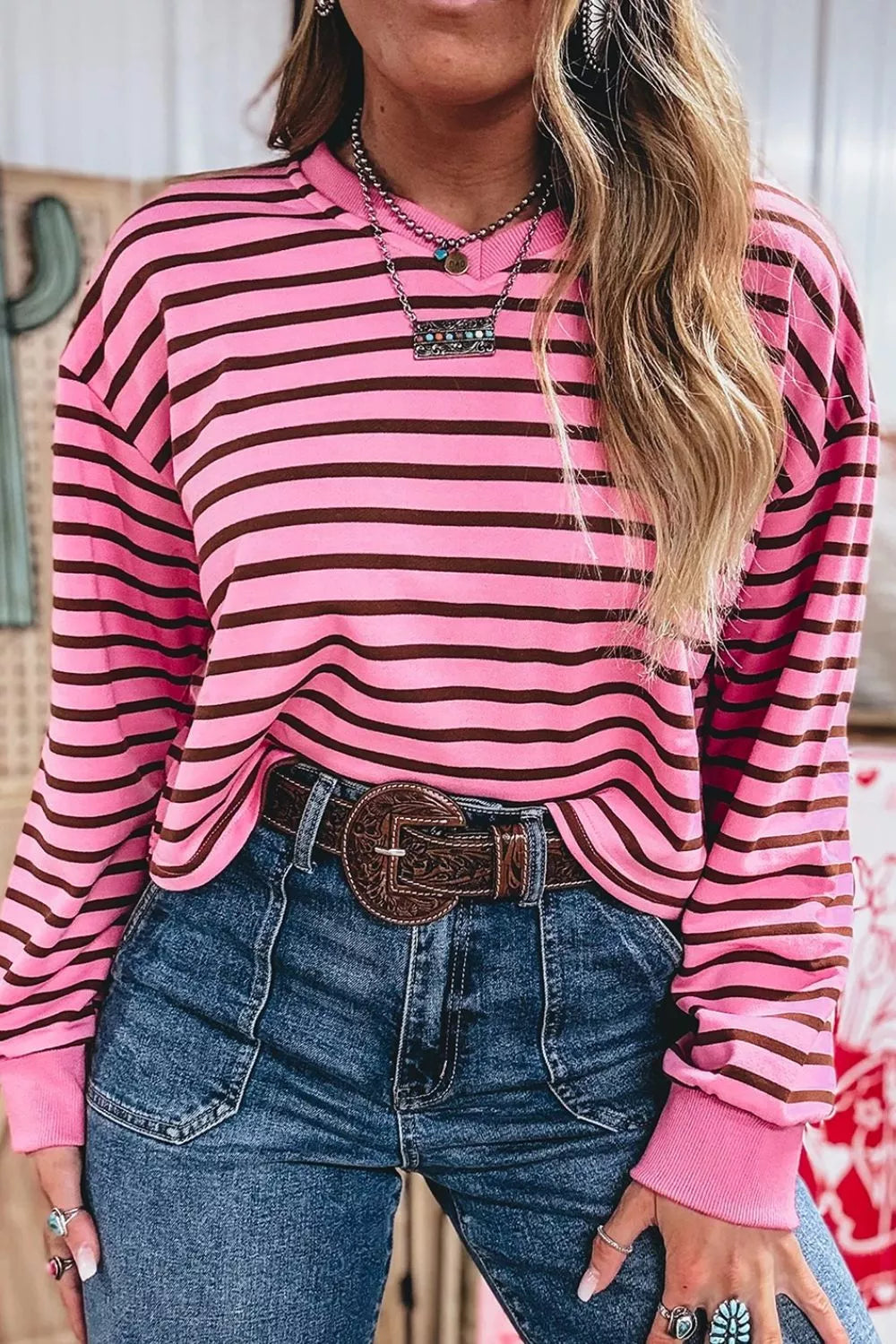 Side view of the striped v neck top showing the relaxed body