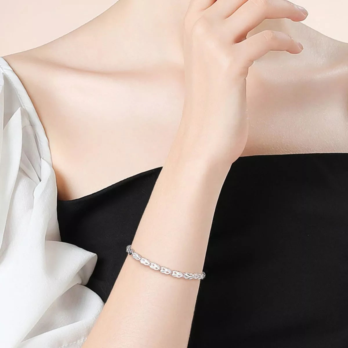 Heart link bracelet shown at an angle to catch the polish