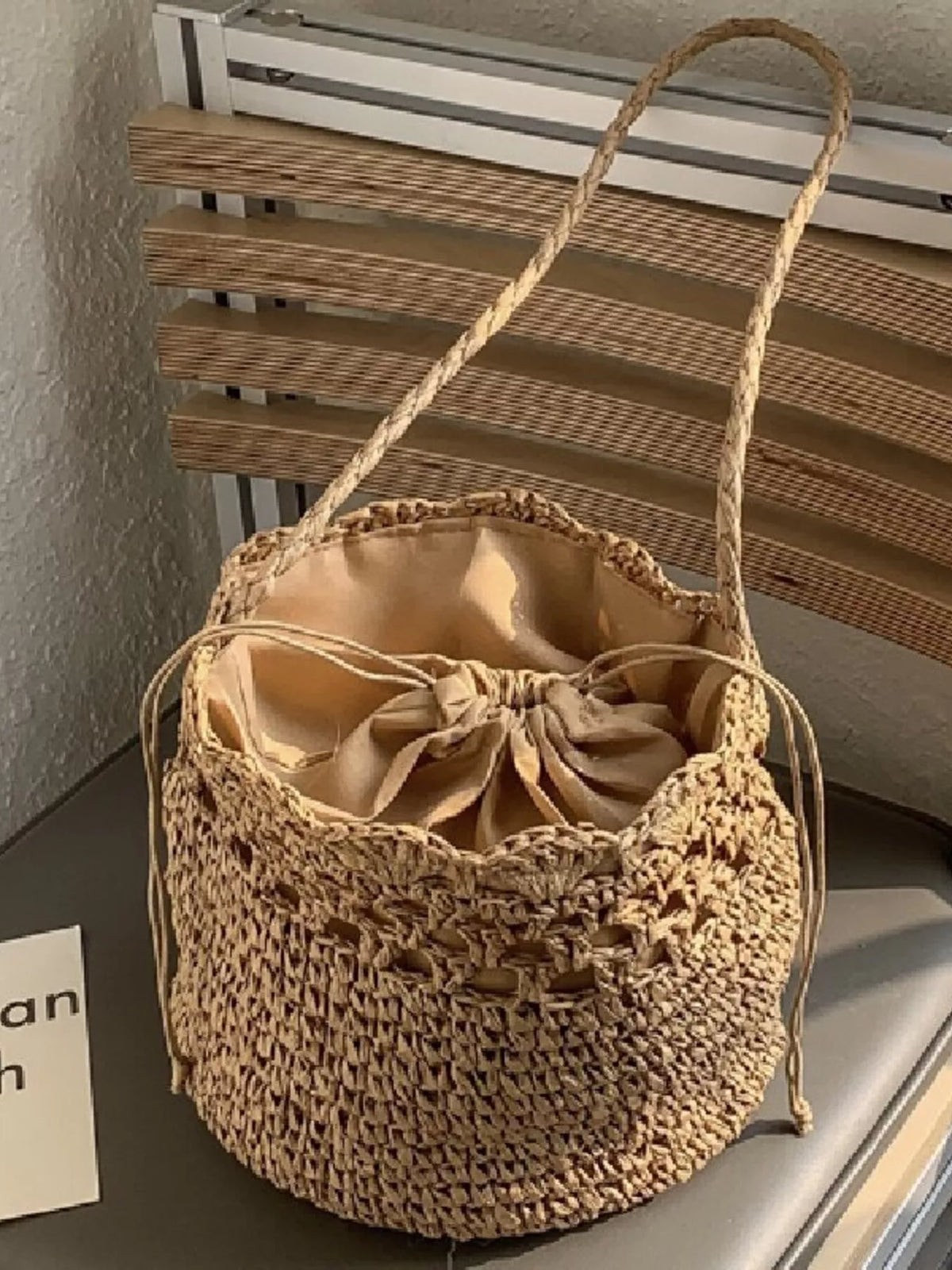 Woven straw bucket bag side profile