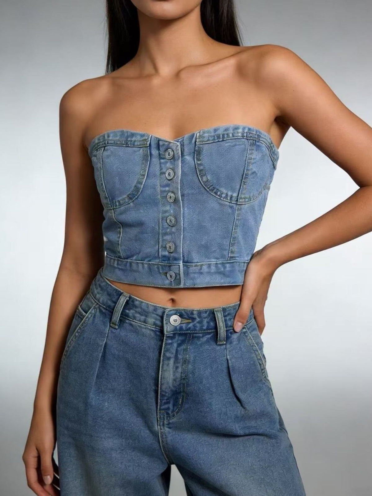 Side view of the strapless denim top showing the cropped length