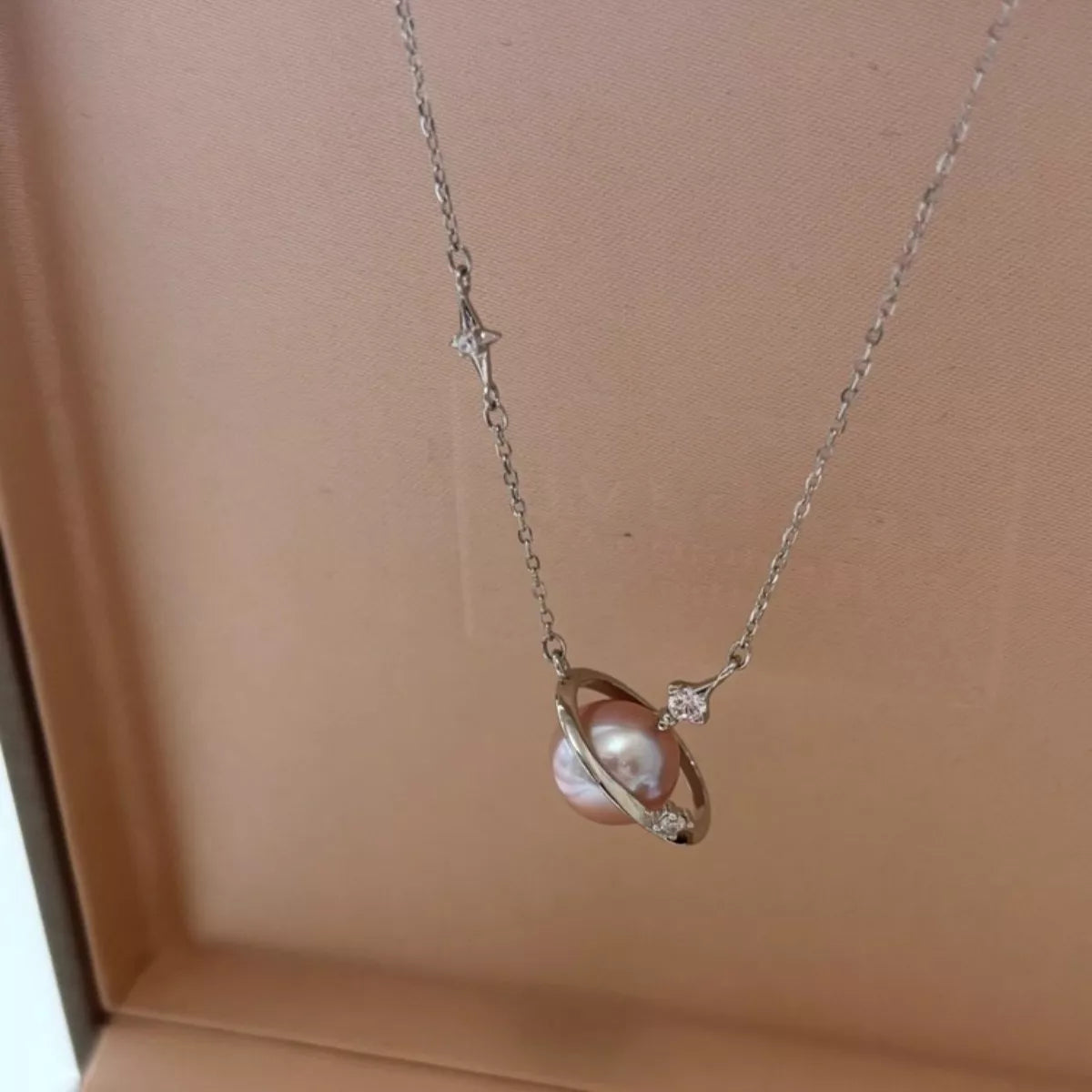 Planet pearl pendant necklace on sterling silver chain close up detail