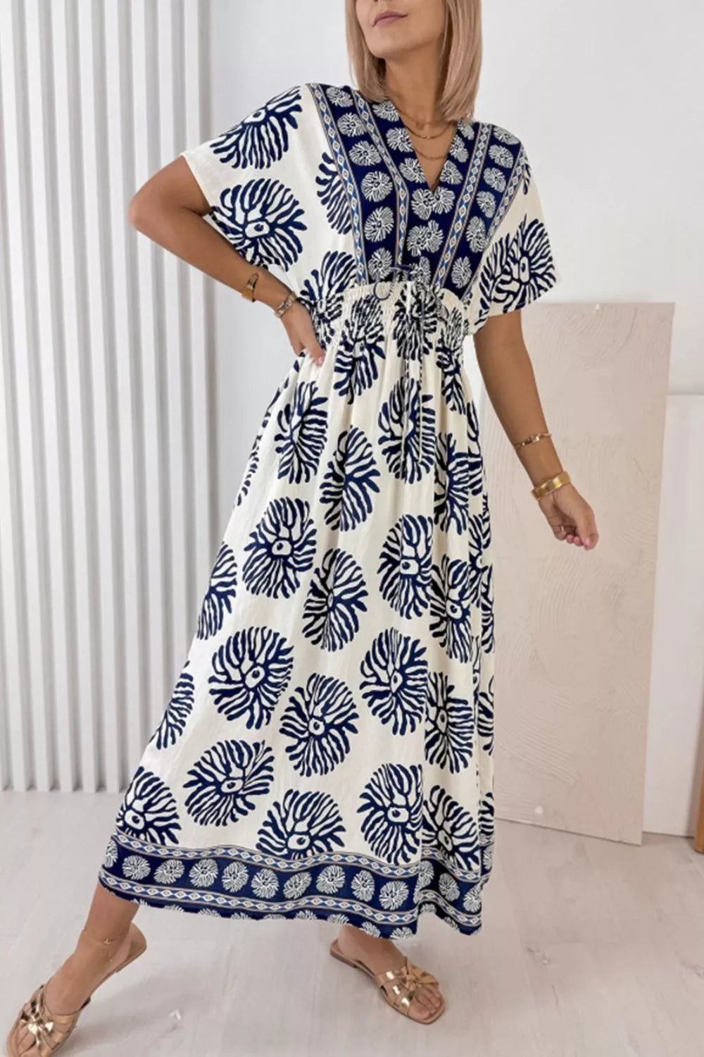 Dusty blue floral dress shown on a model