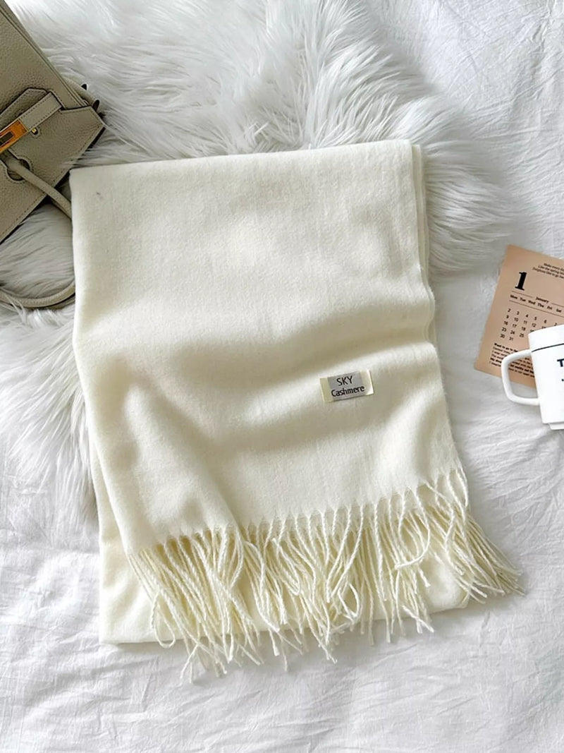 Fringe solid color scarf draped around the neck